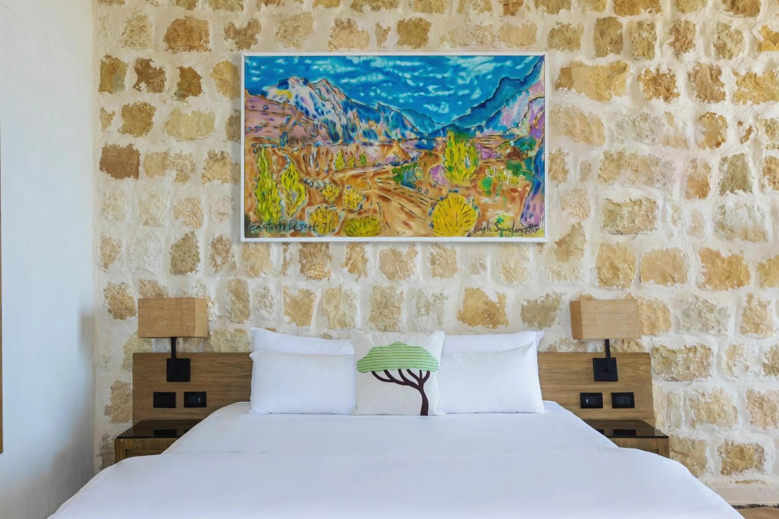 Bed in Wadi Sabarah Lodge