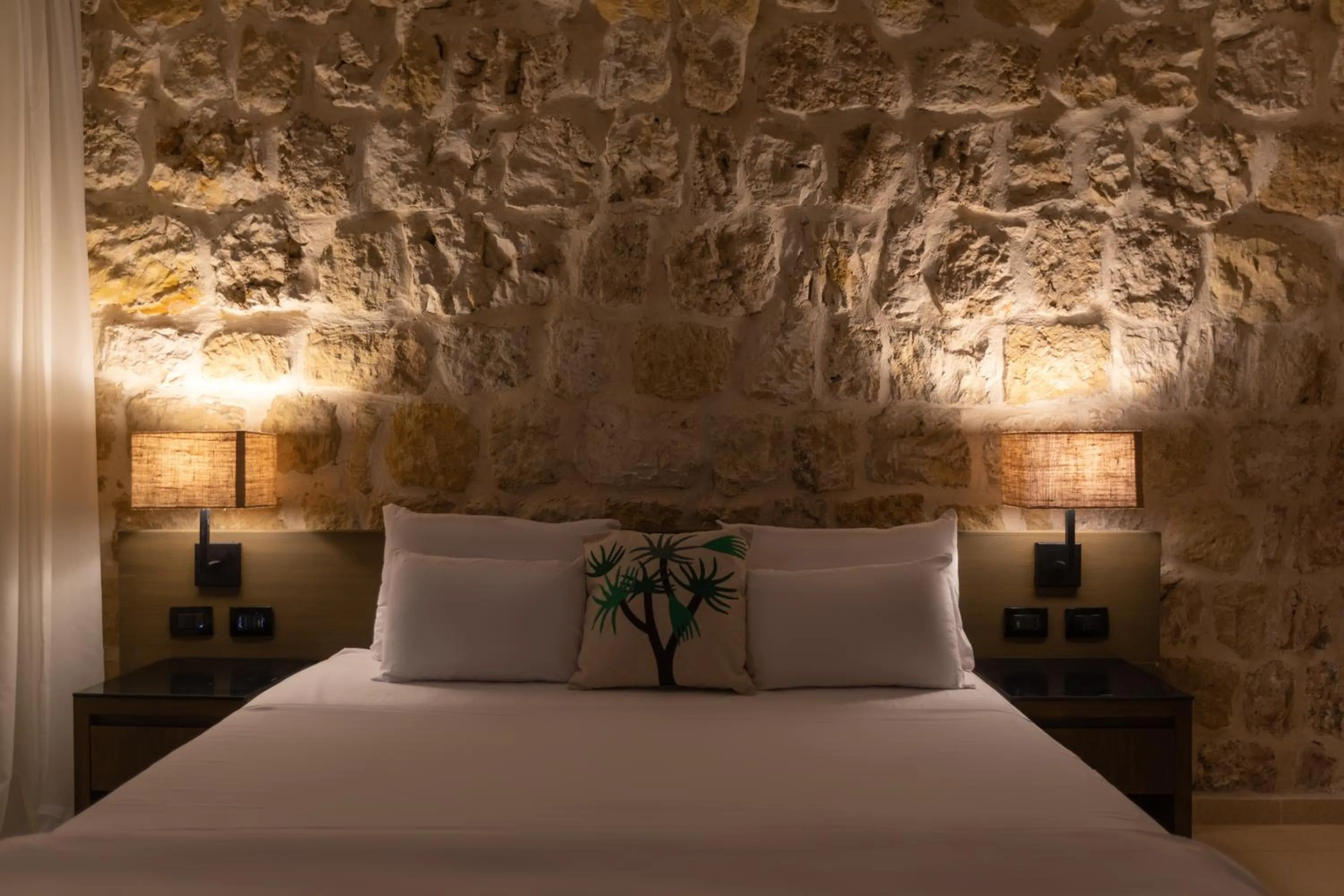 Bed in Wadi Sabarah Lodge