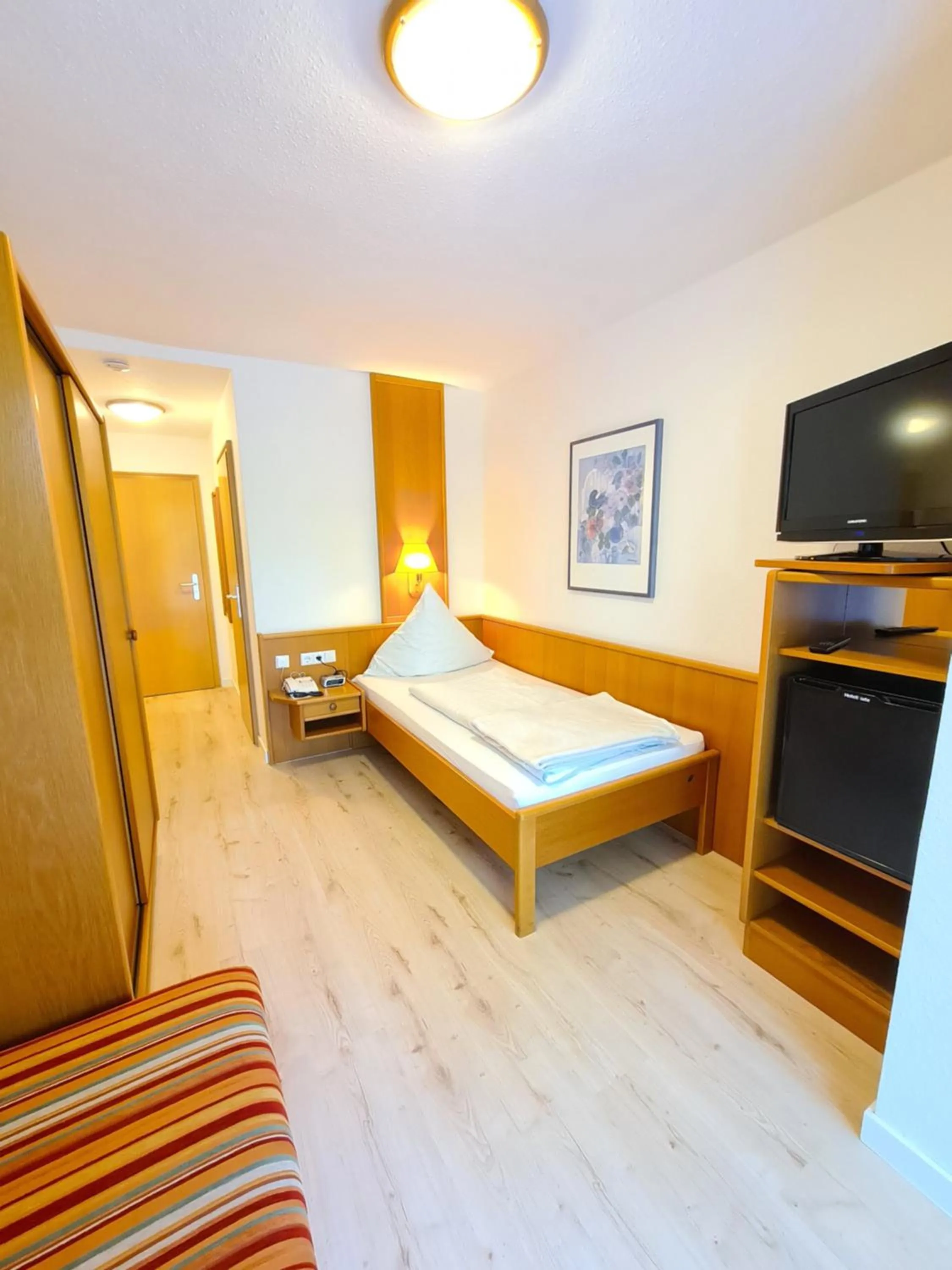 Photo of the whole room, Bed in Thermenhotel Tannenhof - Ihr Wohlfühl-Hotel