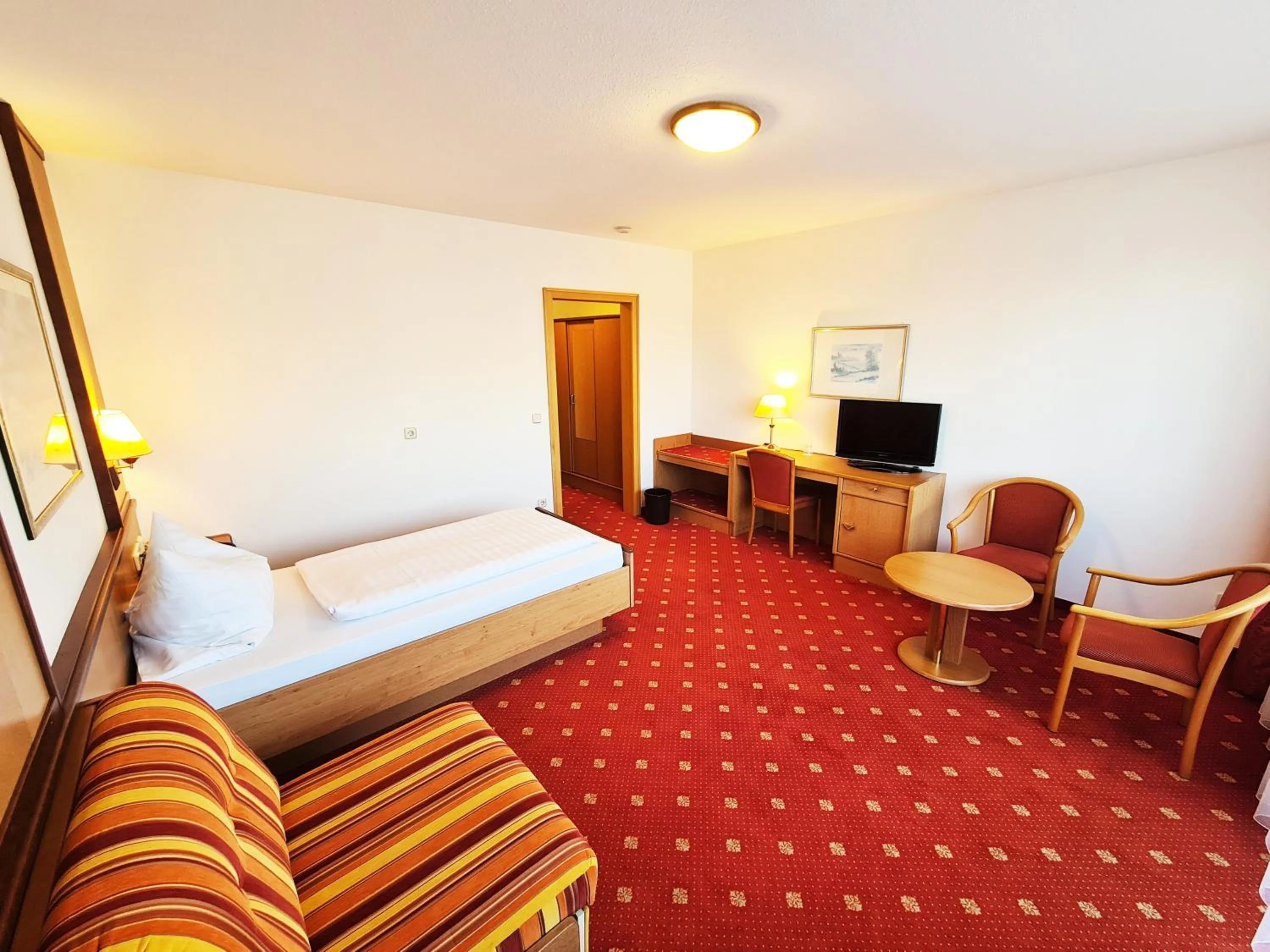 Living room, Bed in Thermenhotel Tannenhof - Ihr Wohlfühl-Hotel