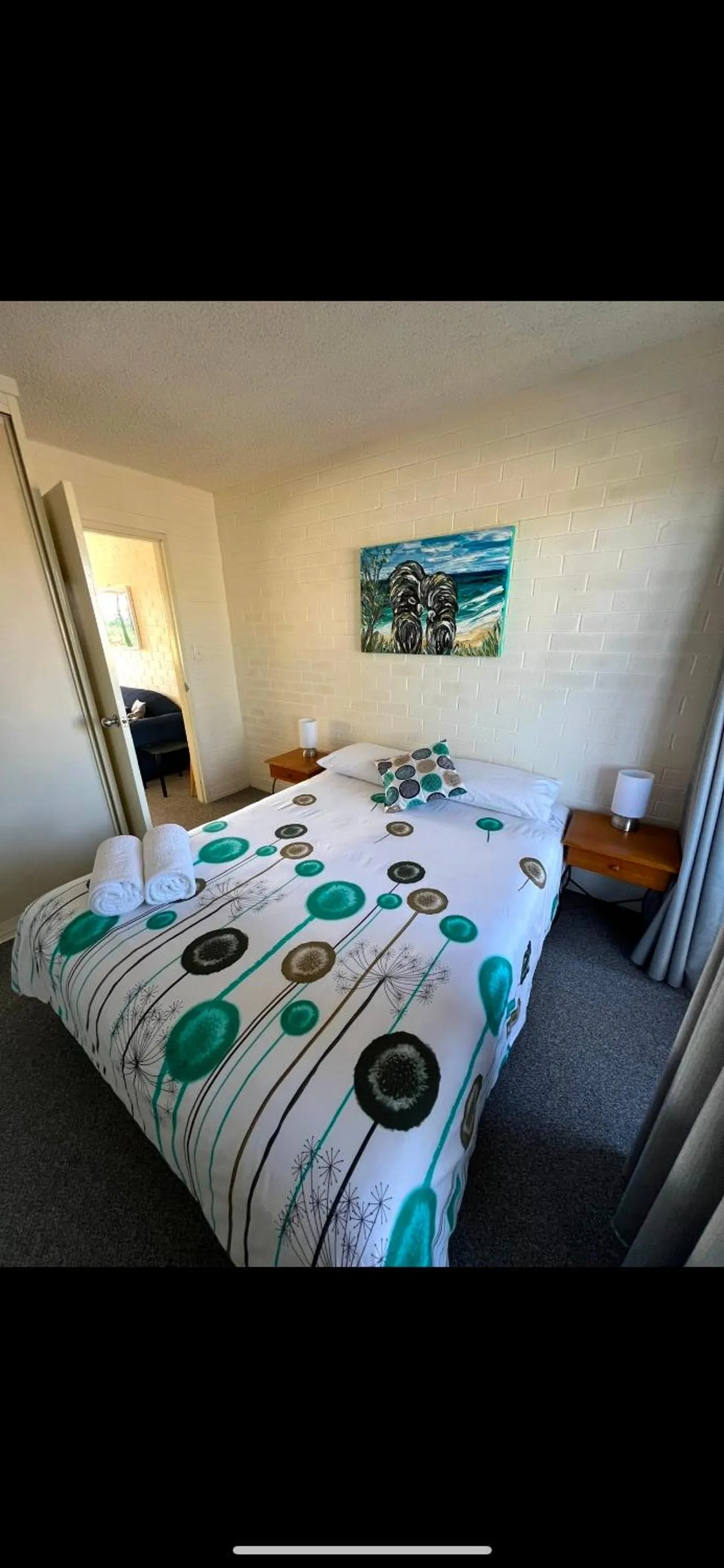 Bed in Narooma Palms Holiday Apartments