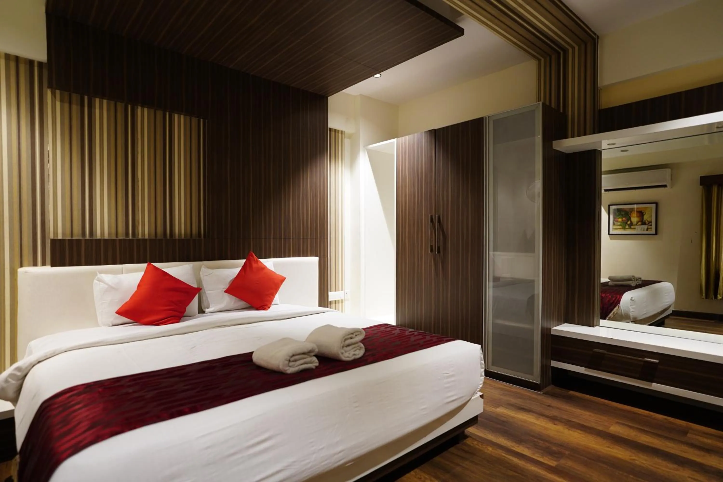 Bed in Emarald Hotel Calicut