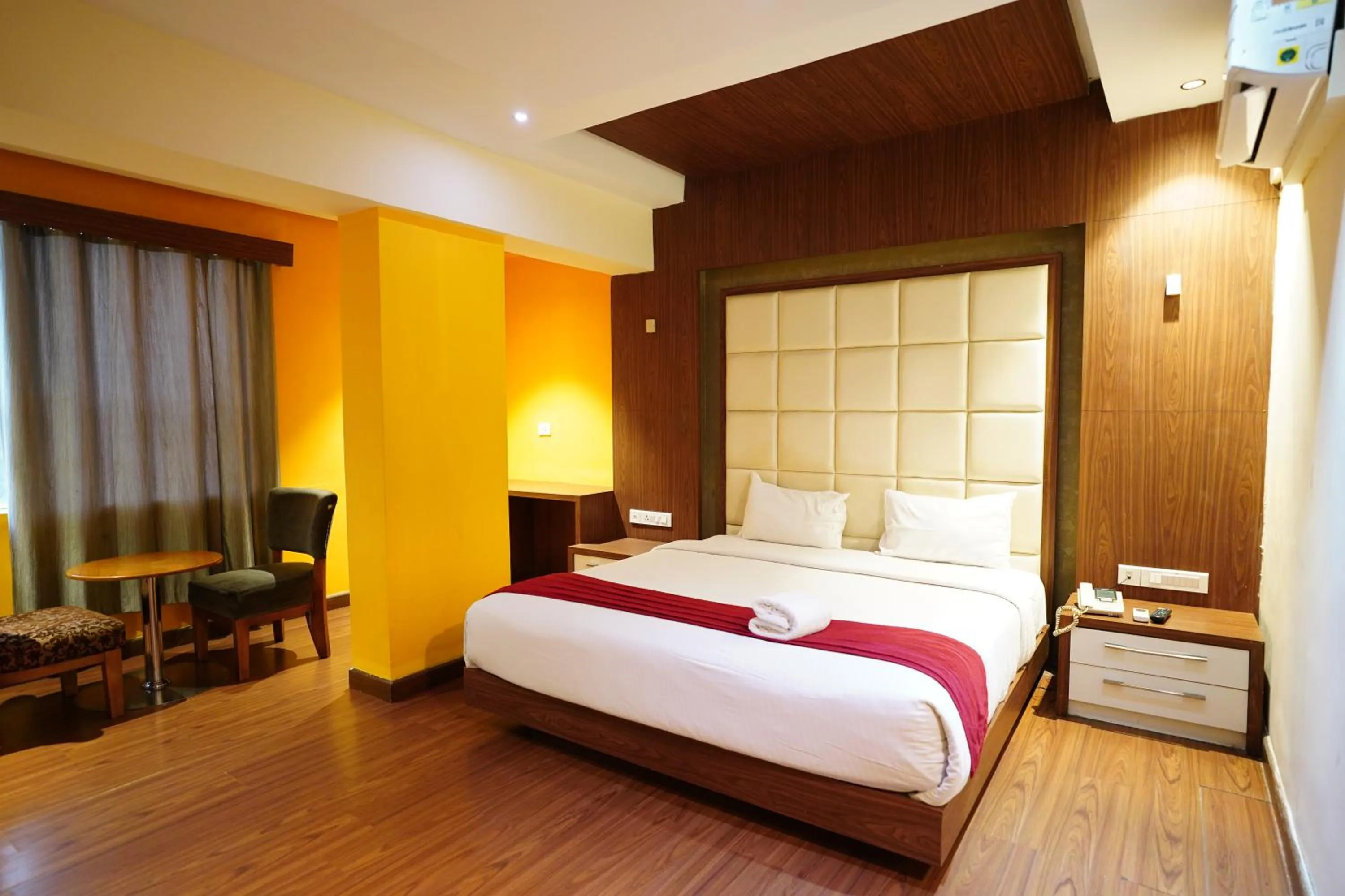 Bed in Emarald Hotel Calicut