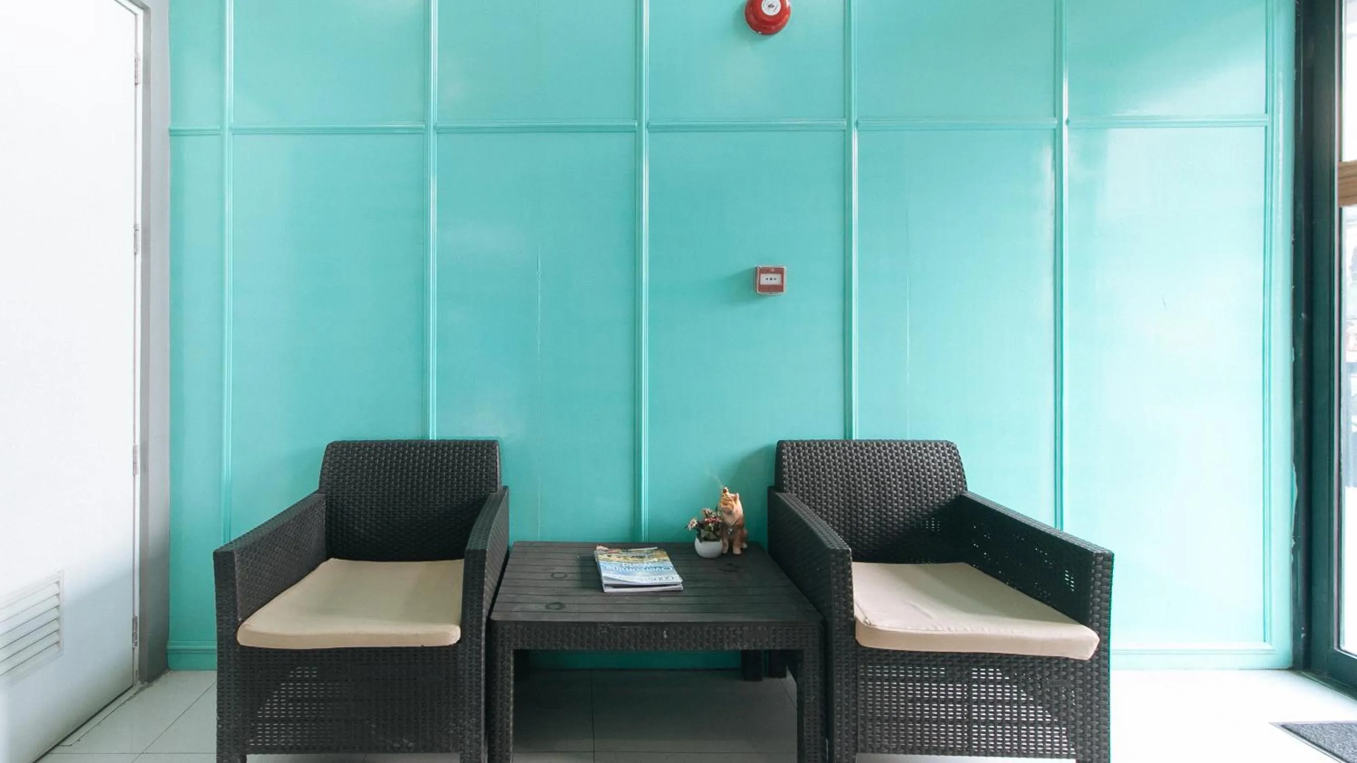 Seating area in Filmore Suites Makati by RedDoorz