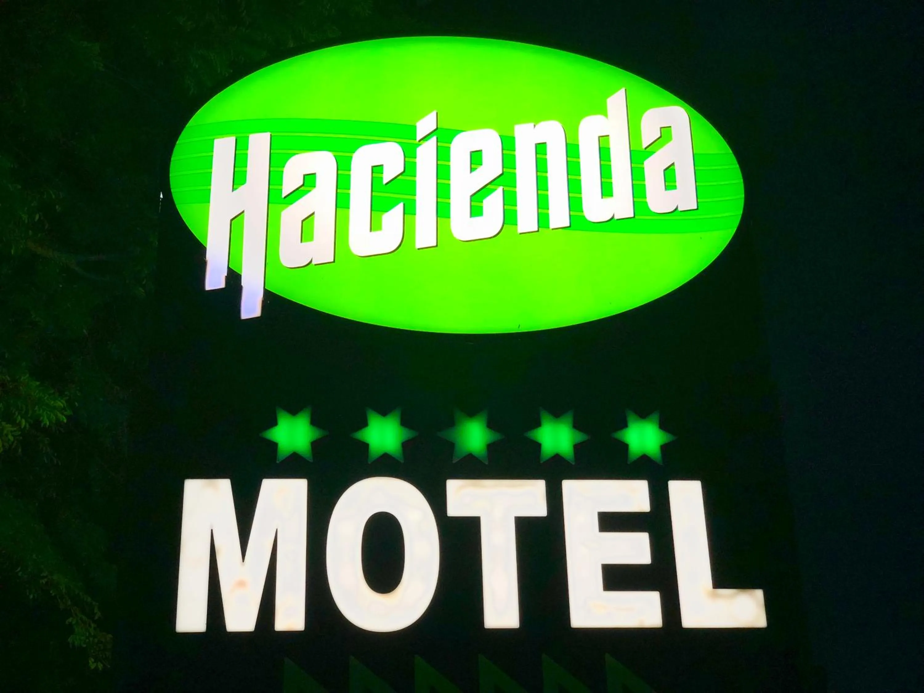 Property logo or sign in Hacienda Motor Lodge