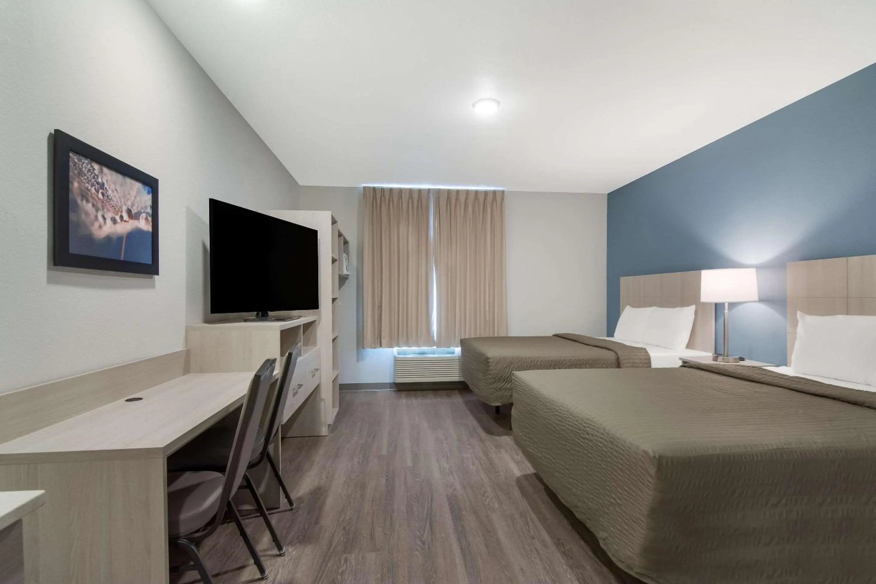 Bedroom in WoodSpring Suites Morrisville - Raleigh Durham Airport