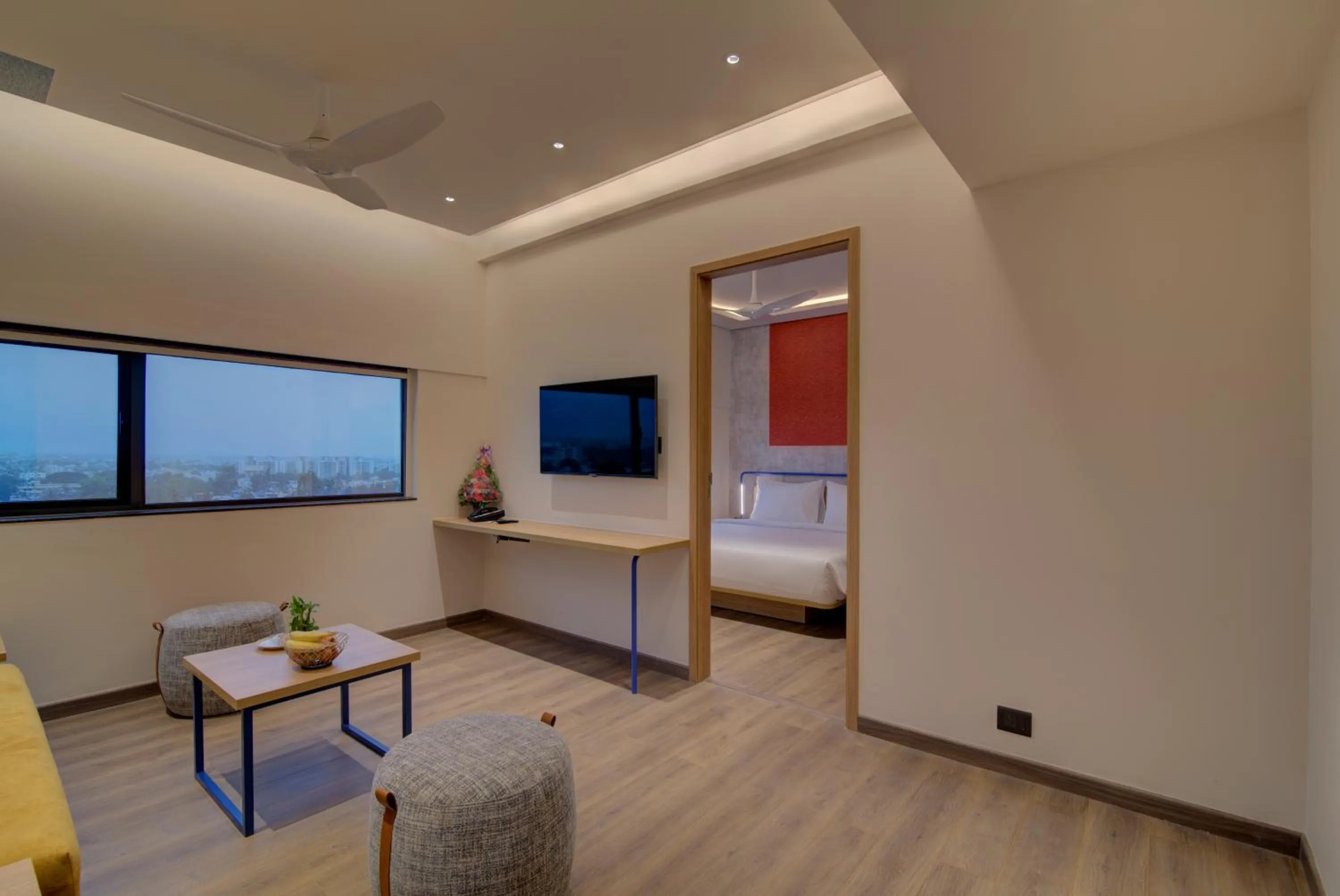 Communal lounge/ TV room, Bed in 7 Apple Hotel Nashik