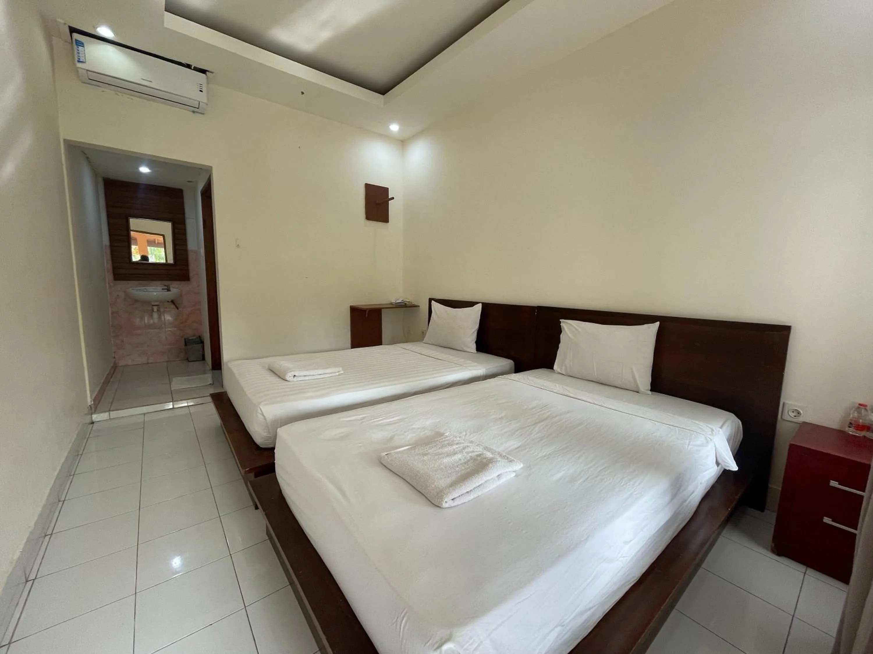 Bed in Melati Resort & Hotel Kuta Lombok