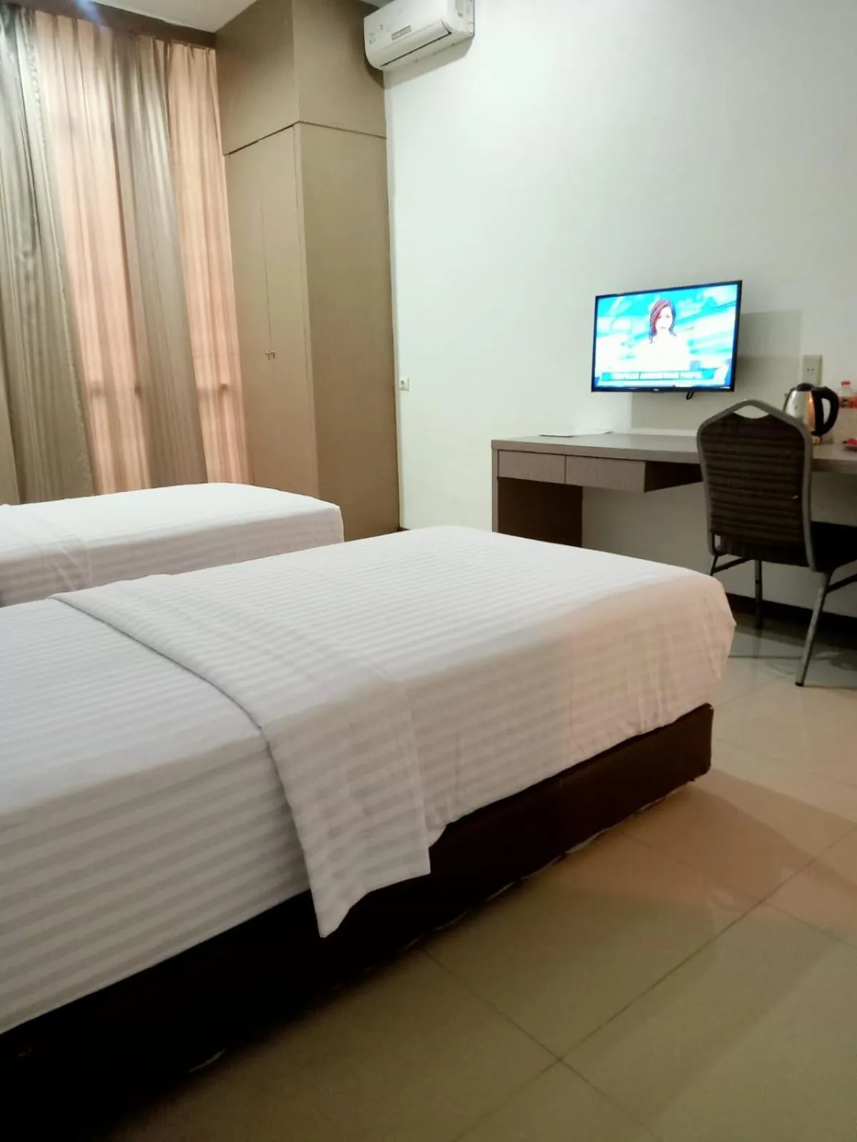 Bed in Putra Mulia Hotel Medan