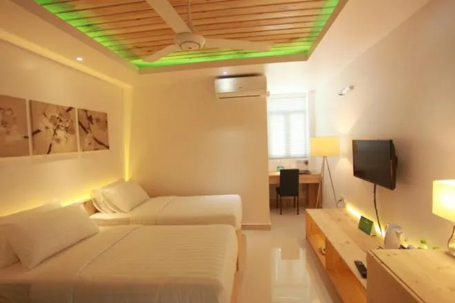 Bed in PINE LODGE MALDIVES