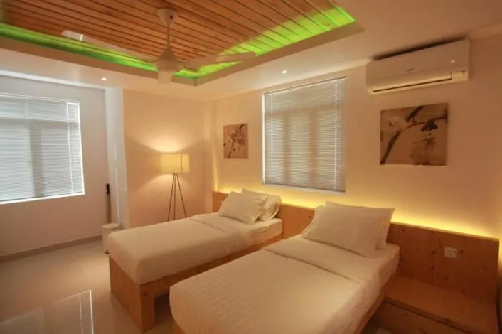 Bed in PINE LODGE MALDIVES