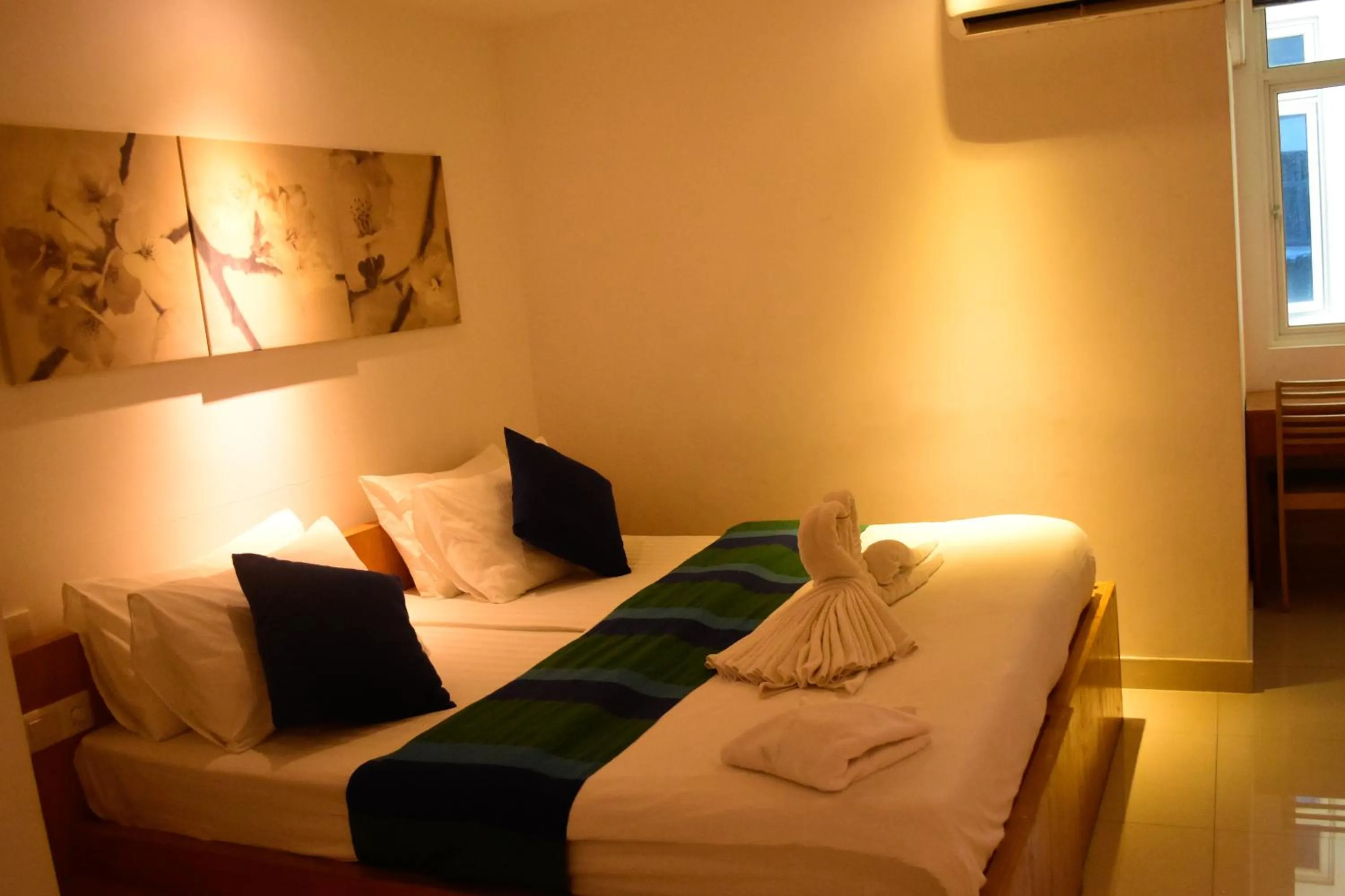 Bed in PINE LODGE MALDIVES