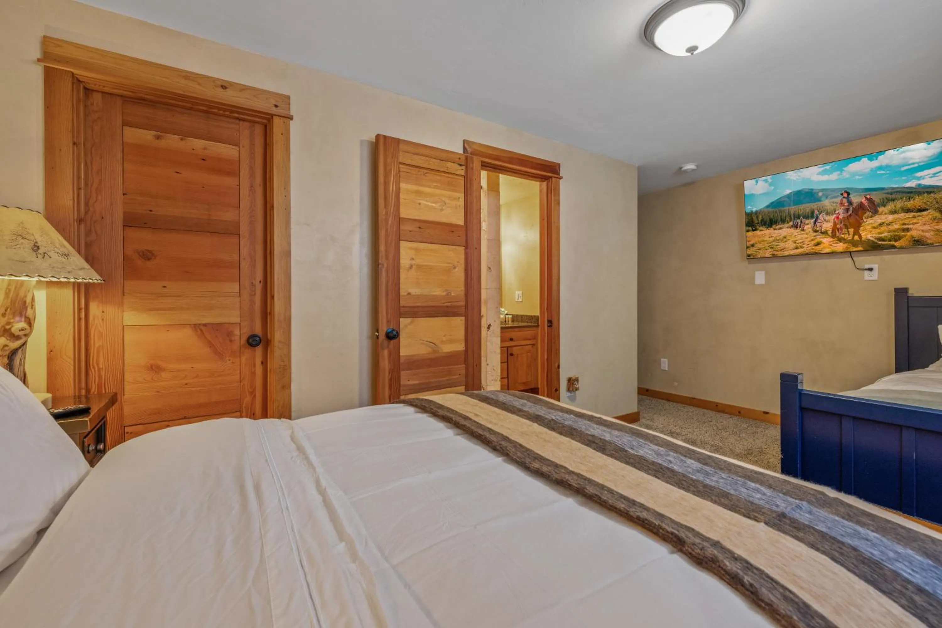 Bed in Liberty Lodge by KABINO Hot Tub Air Hockey 3 Living Rooms 7 bedrooms Boat Launch Reservoir ATV Snowmobile Trails WiFi