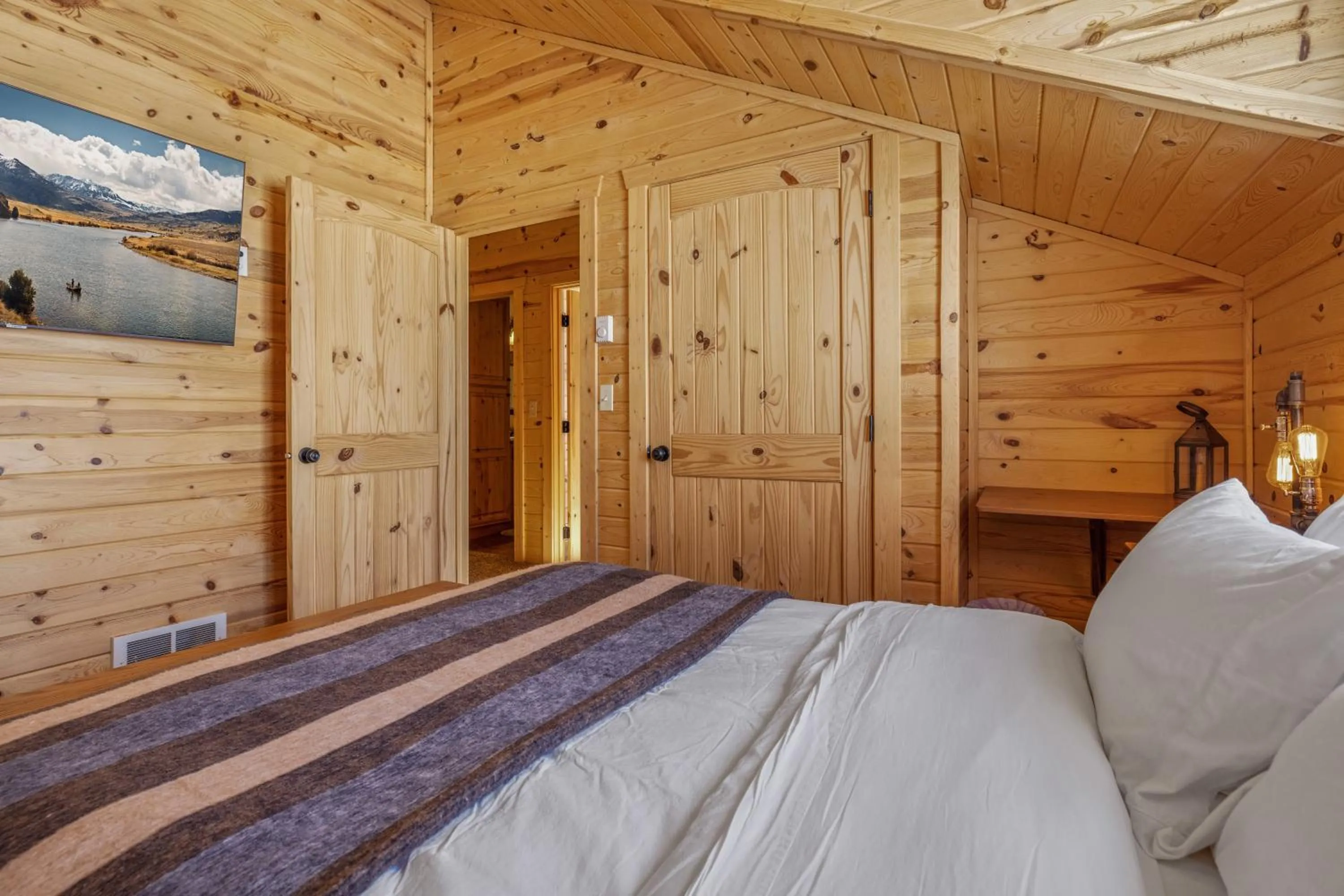 Bed in Liberty Lodge by KABINO Hot Tub Air Hockey 3 Living Rooms 7 bedrooms Boat Launch Reservoir ATV Snowmobile Trails WiFi