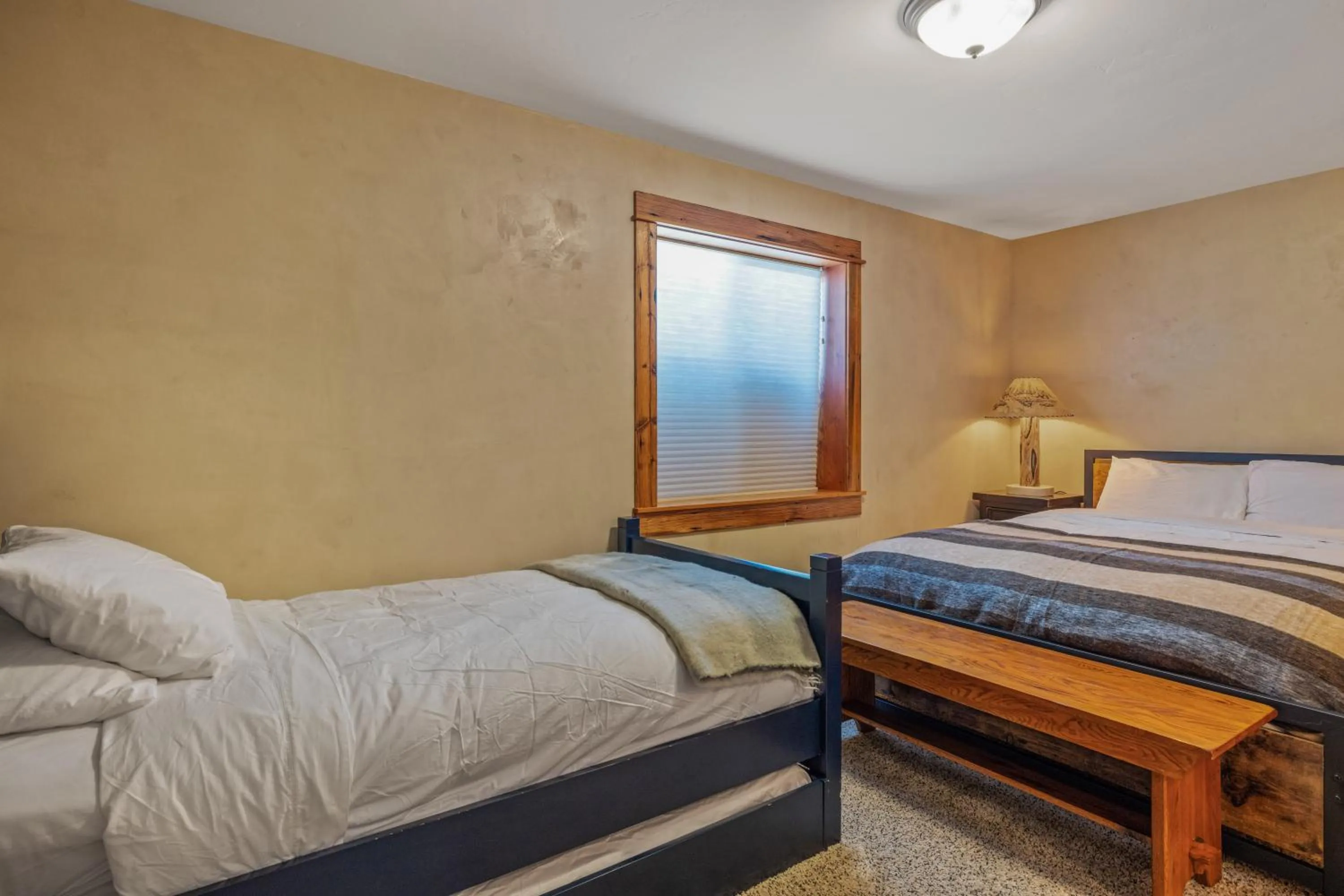 Bed in Liberty Lodge by KABINO Hot Tub Air Hockey 3 Living Rooms 7 bedrooms Boat Launch Reservoir ATV Snowmobile Trails WiFi