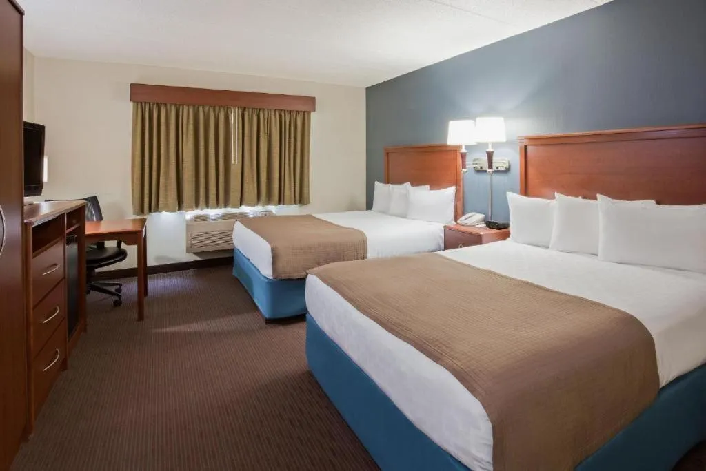 Bed in AmericInn by Wyndham Spencer
