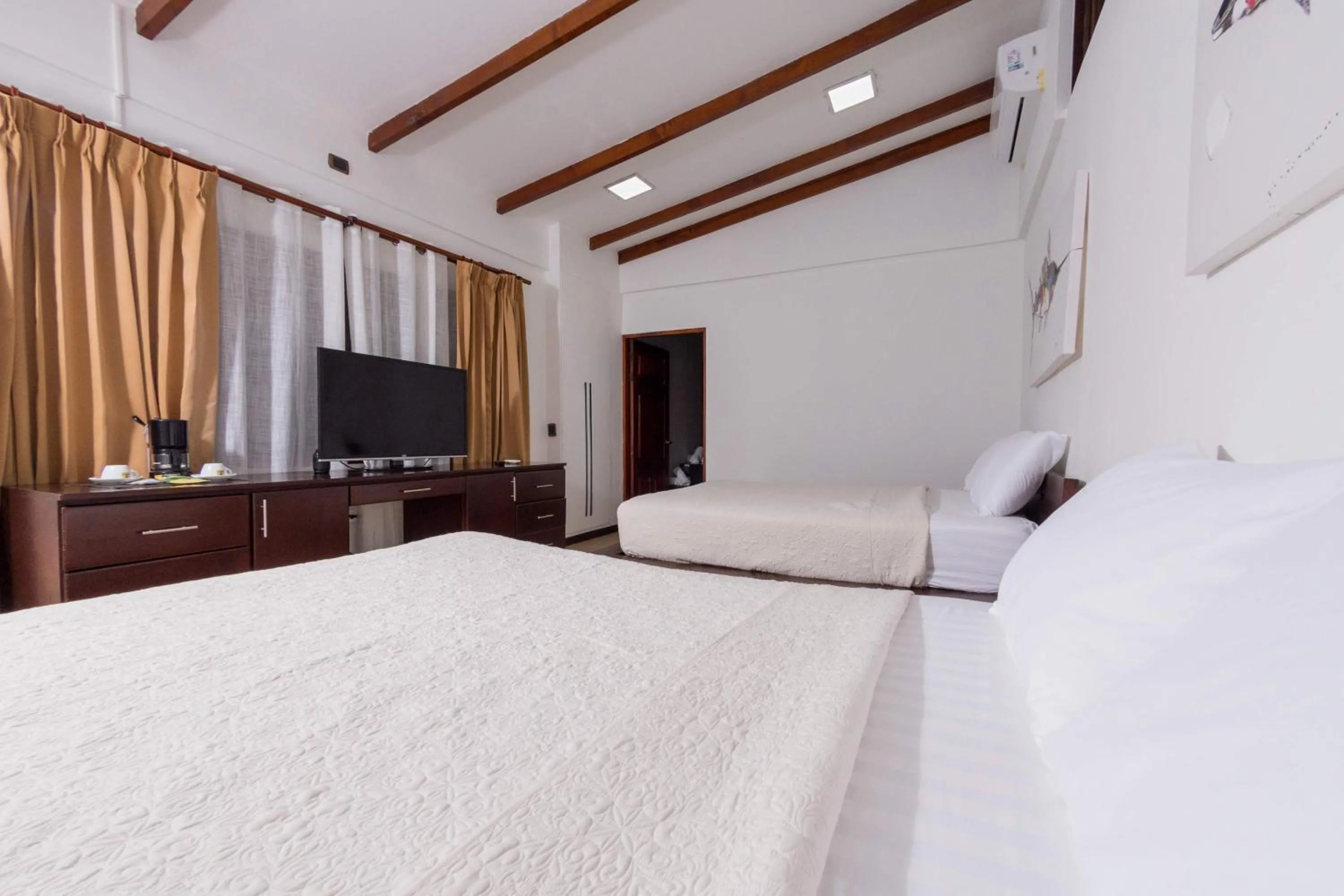 Bedroom in Café de Playa Beach Front Hotel