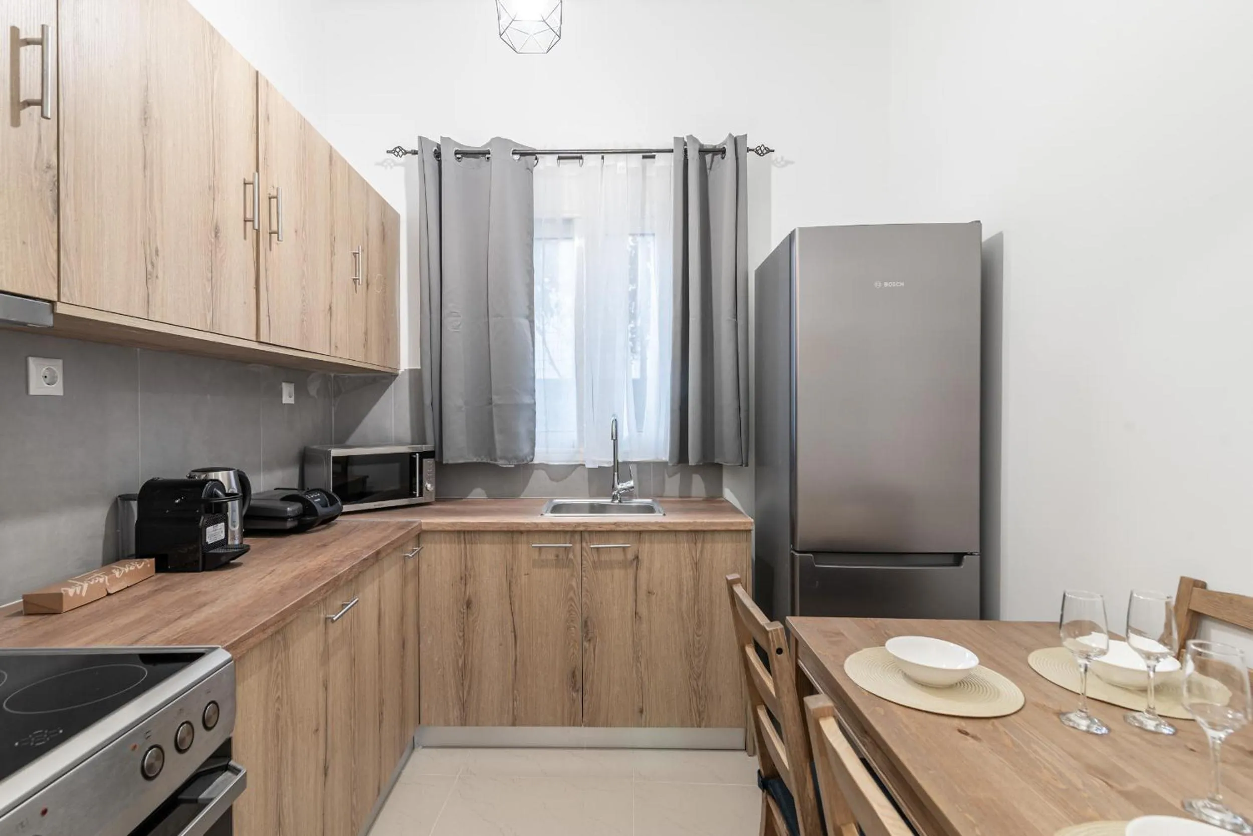 Kitchen or kitchenette in Blue Riviera villas & suites - Alimos 2