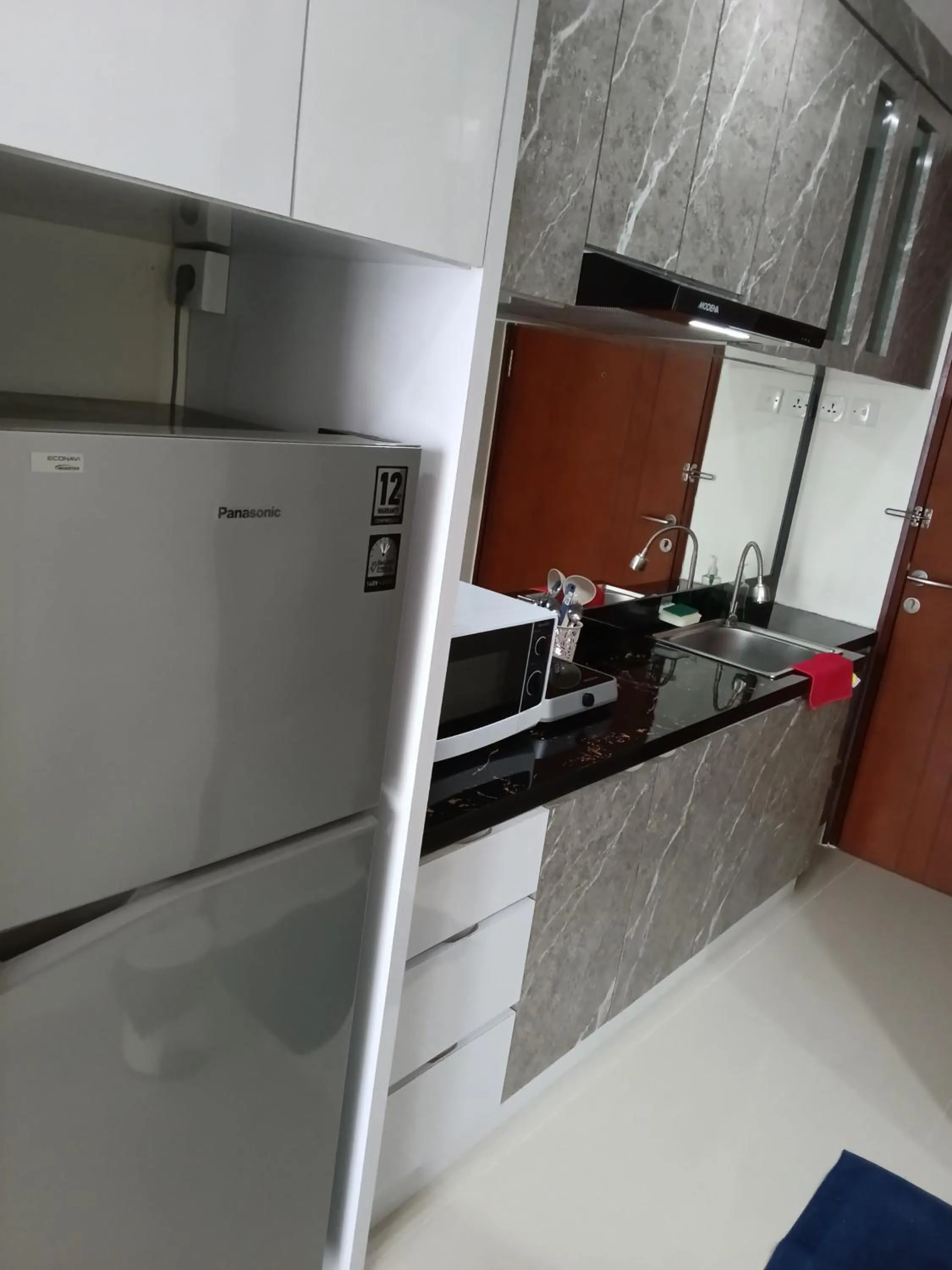 Kitchen or kitchenette in Palam Mansion at Meisterstadt Pollux Habibie Apartment