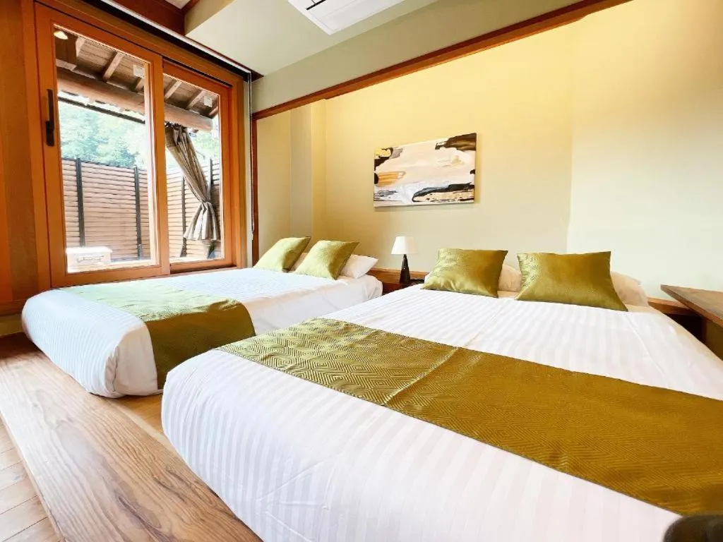 Bed in OWL RESORT ARIFUKU ONSEN