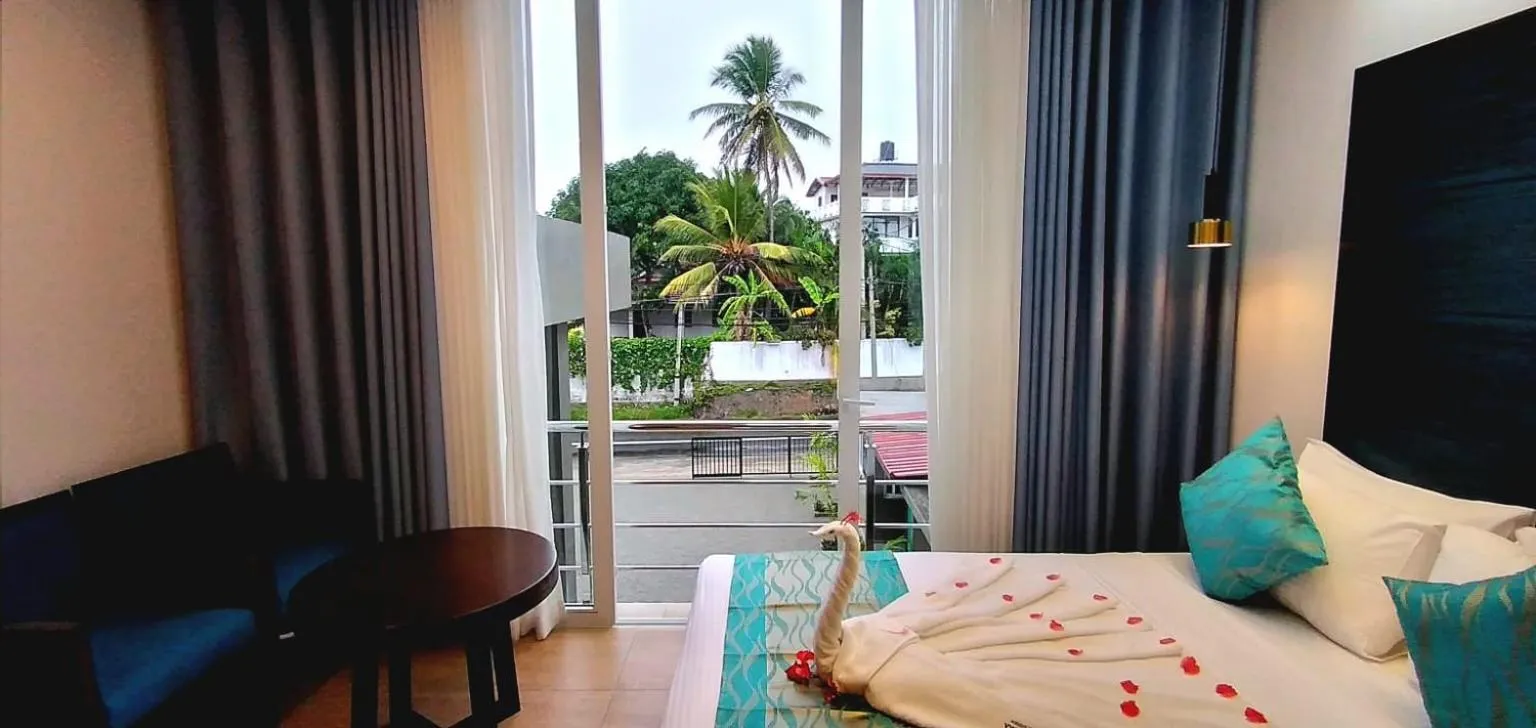 Bed, Seating Area in Grand Samudra Hotel