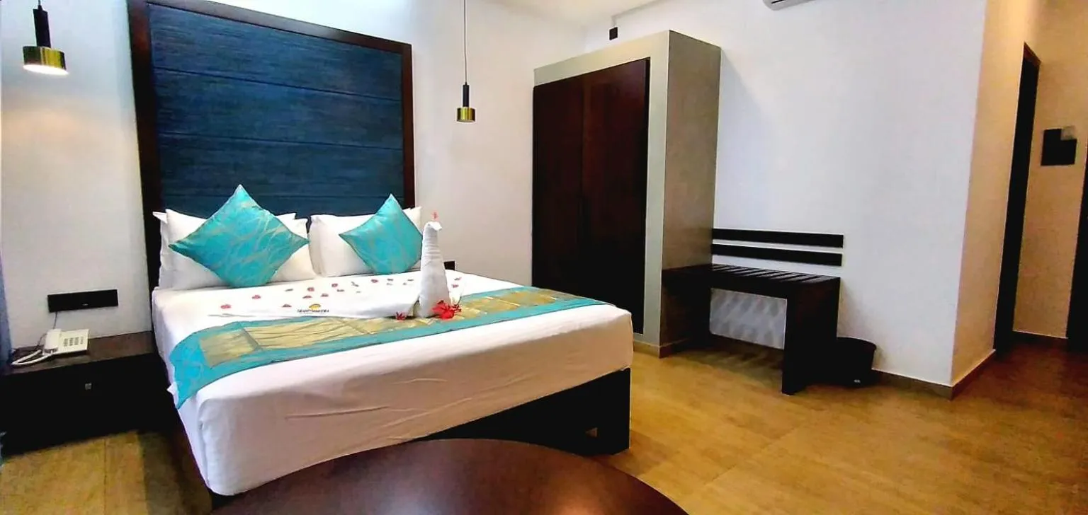 Bed in Grand Samudra Hotel