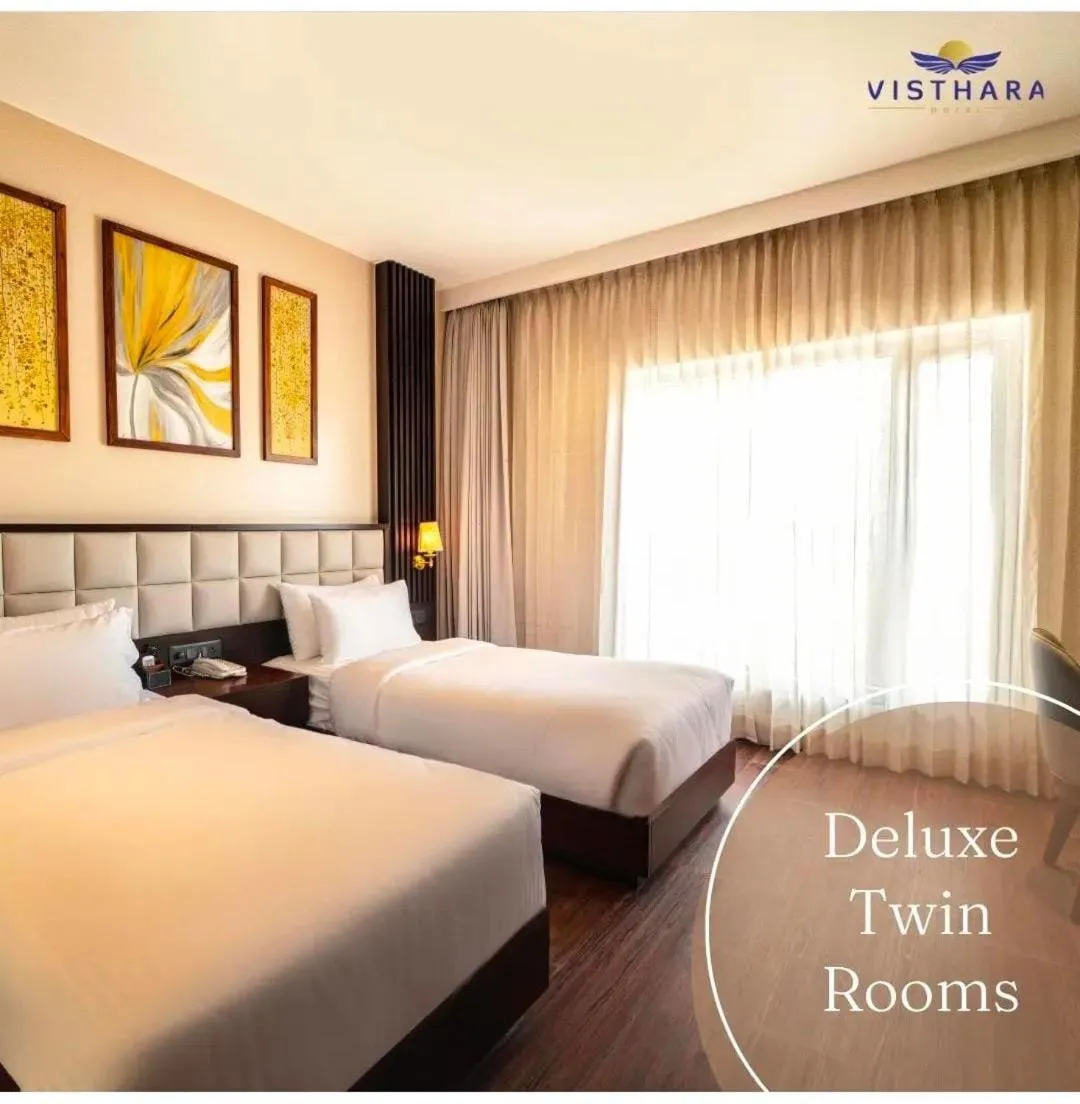 Bed in Visthara Hotel