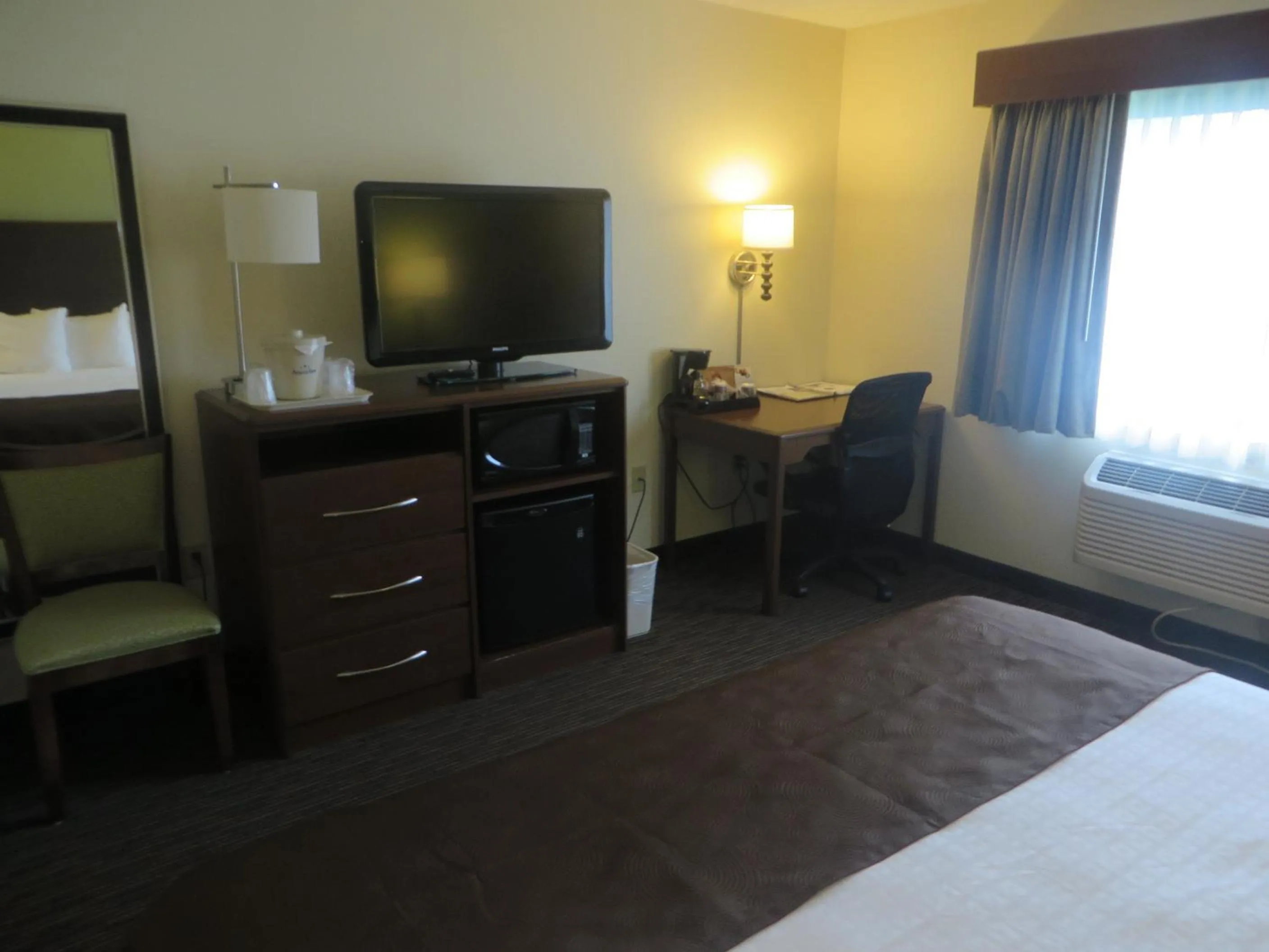 Bed in AmericInn by Wyndham Rice Lake