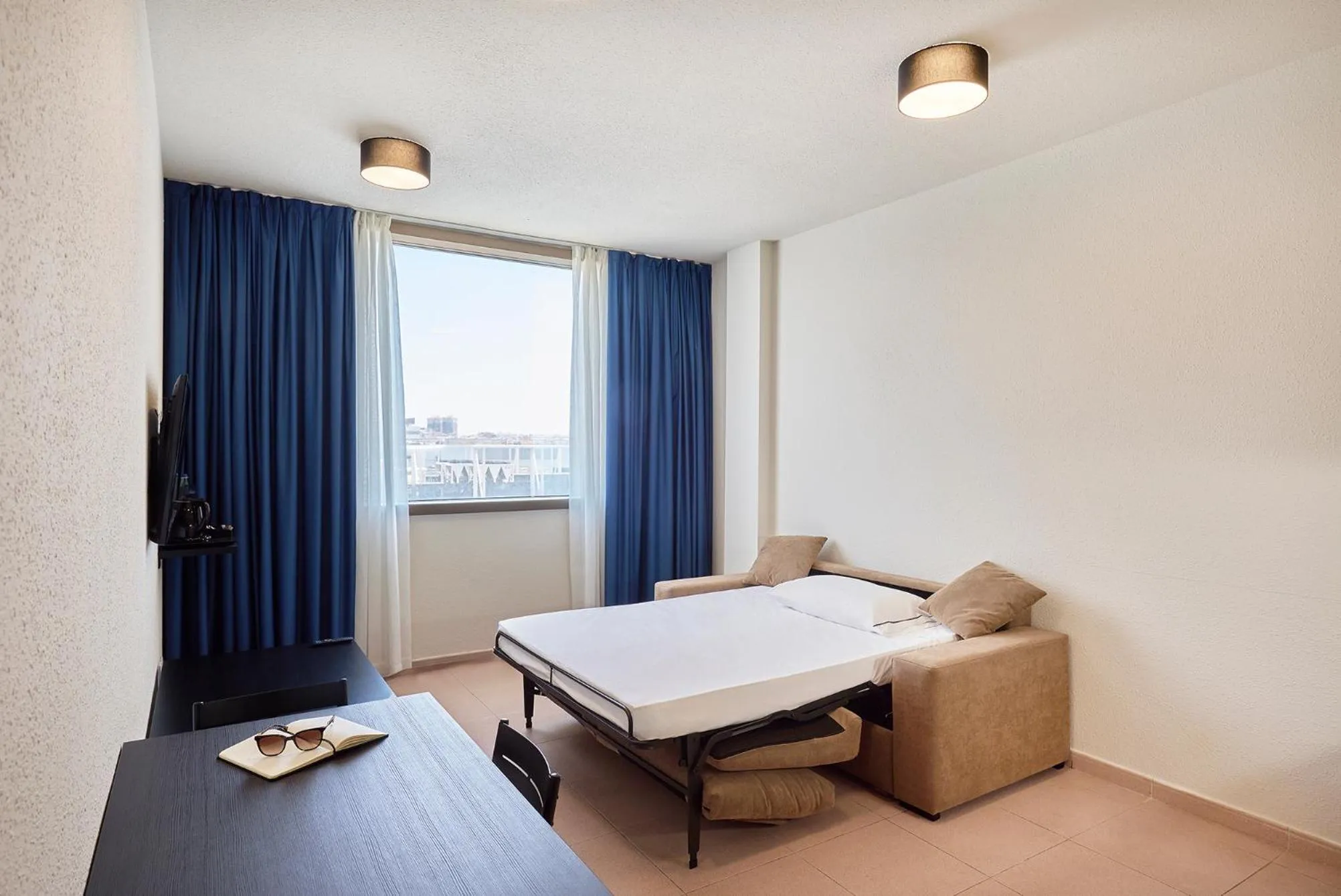 Living room, Bed in Hesperia Sant Joan