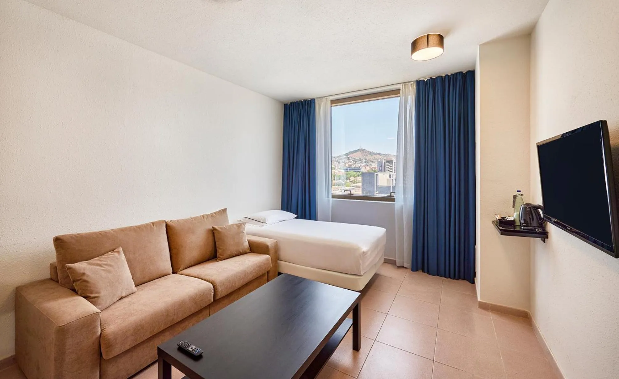 Living room, Bed in Hesperia Sant Joan