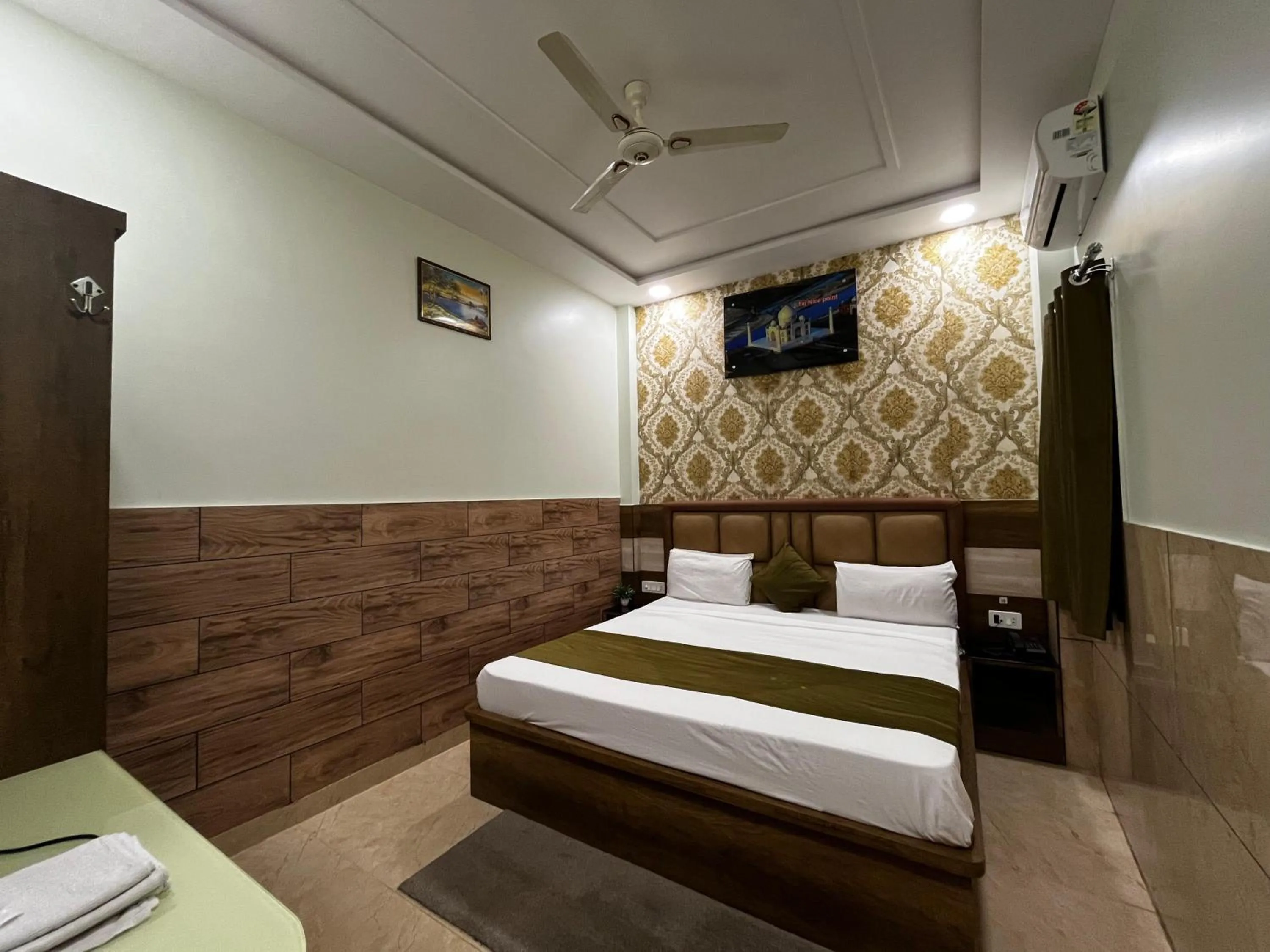 Photo of the whole room, Bed in Taj Nice Point Manage by Taj Sunrise Group