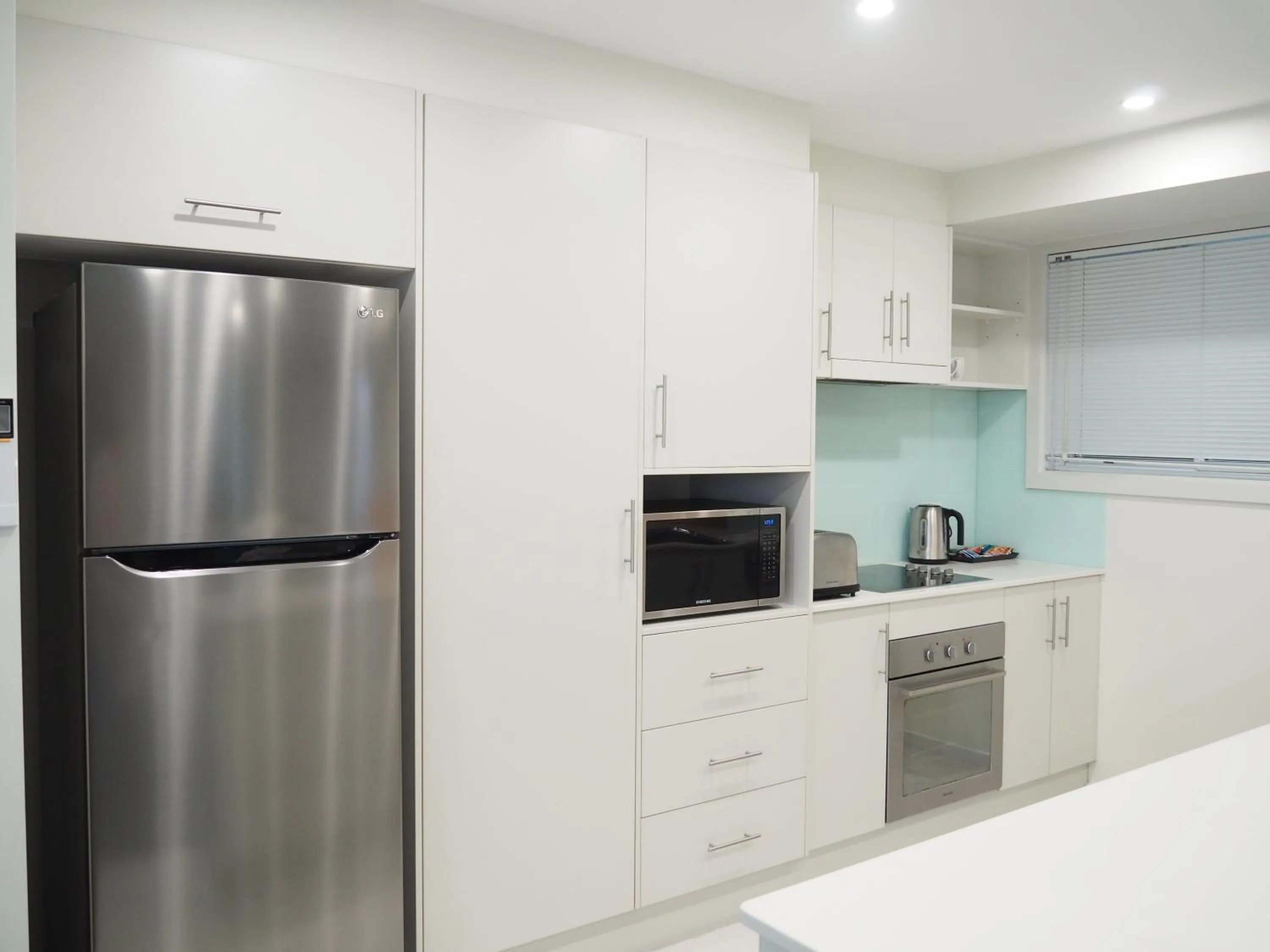 Kitchen or kitchenette in Warners Bay Apartments