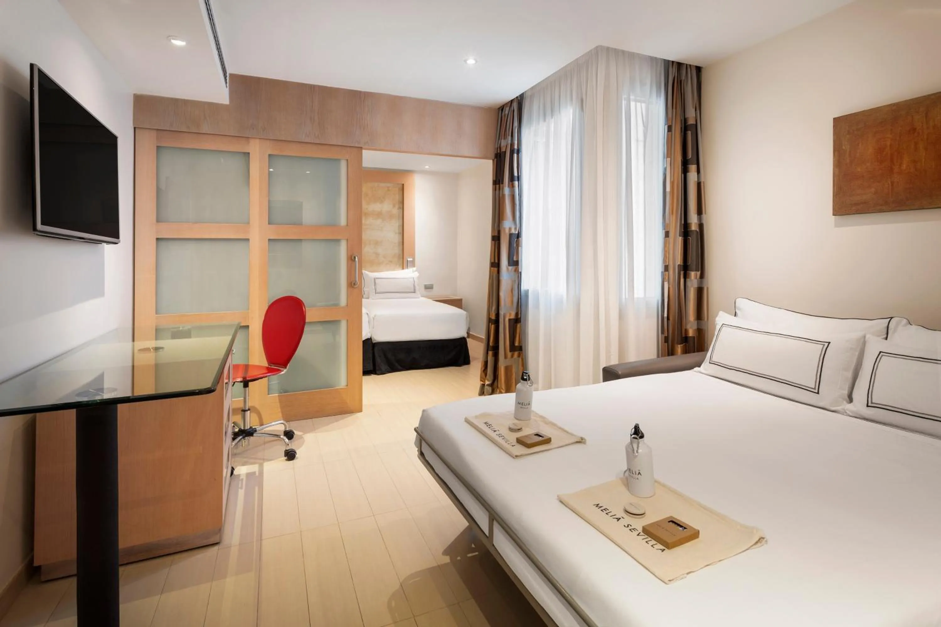 Communal lounge/ TV room, Bed in Melia Sevilla