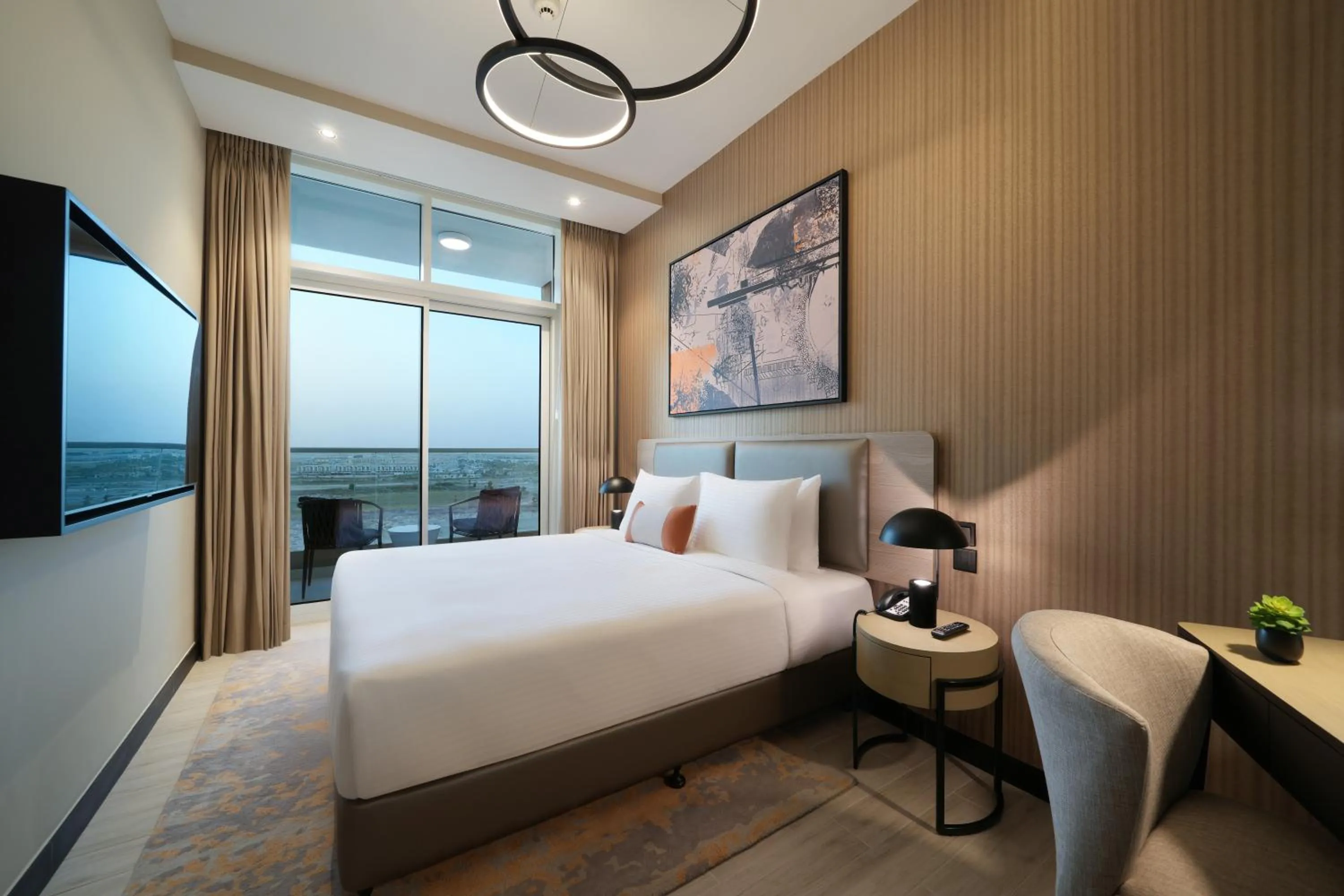 Bed in DAMAC Hills 2 Hotel, an Edge by Rotana Hotel