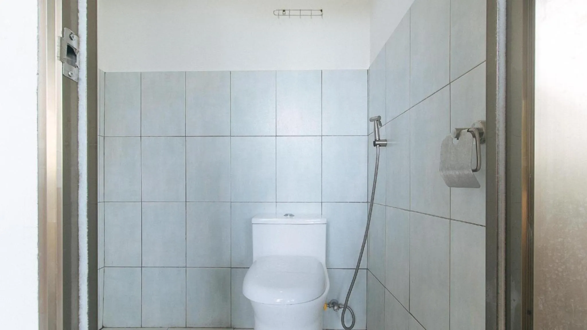 Shower in Marco s Tourist Inn by RedDoorz