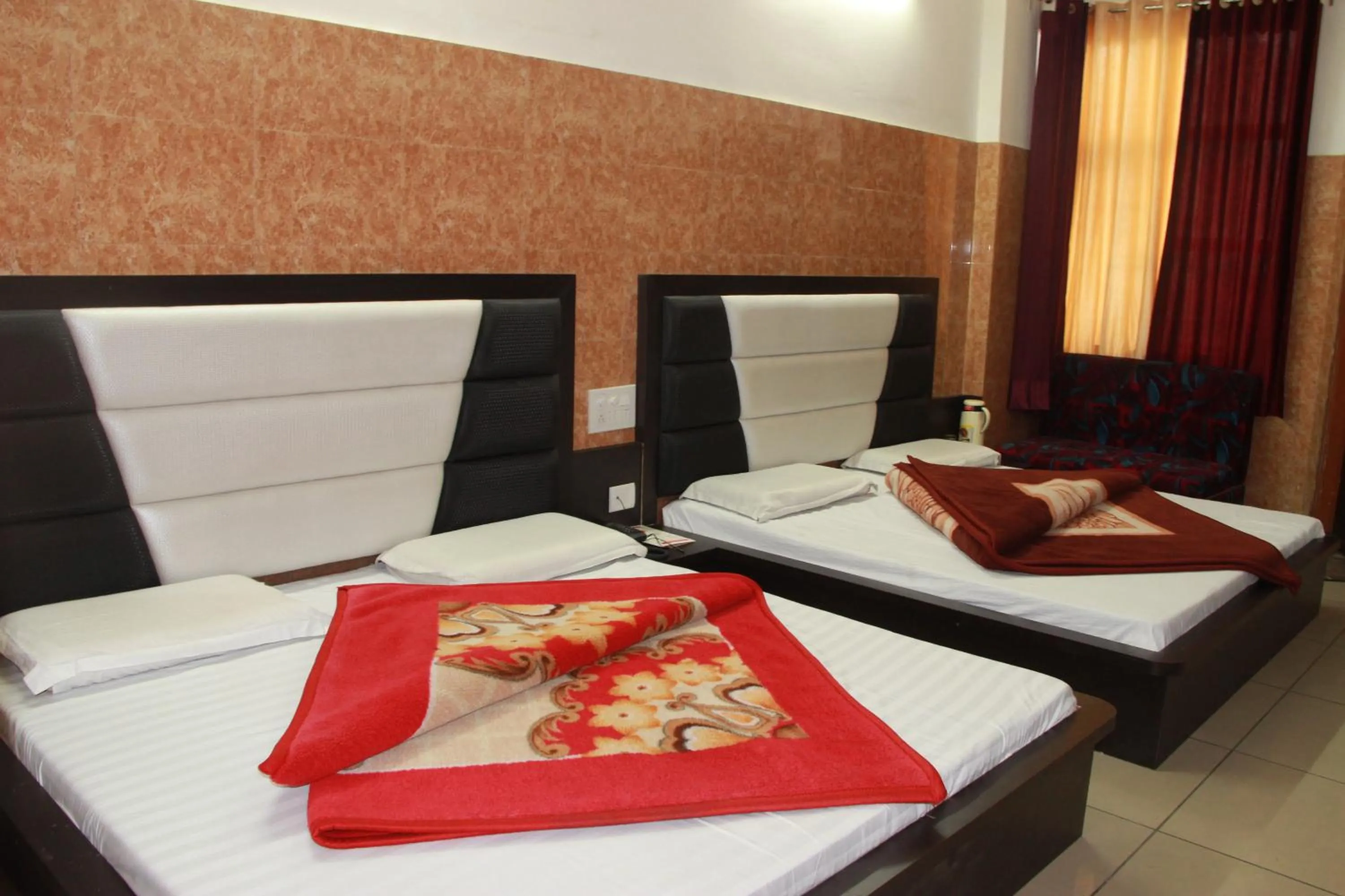 Bed in AASHIRWAD HOTEL