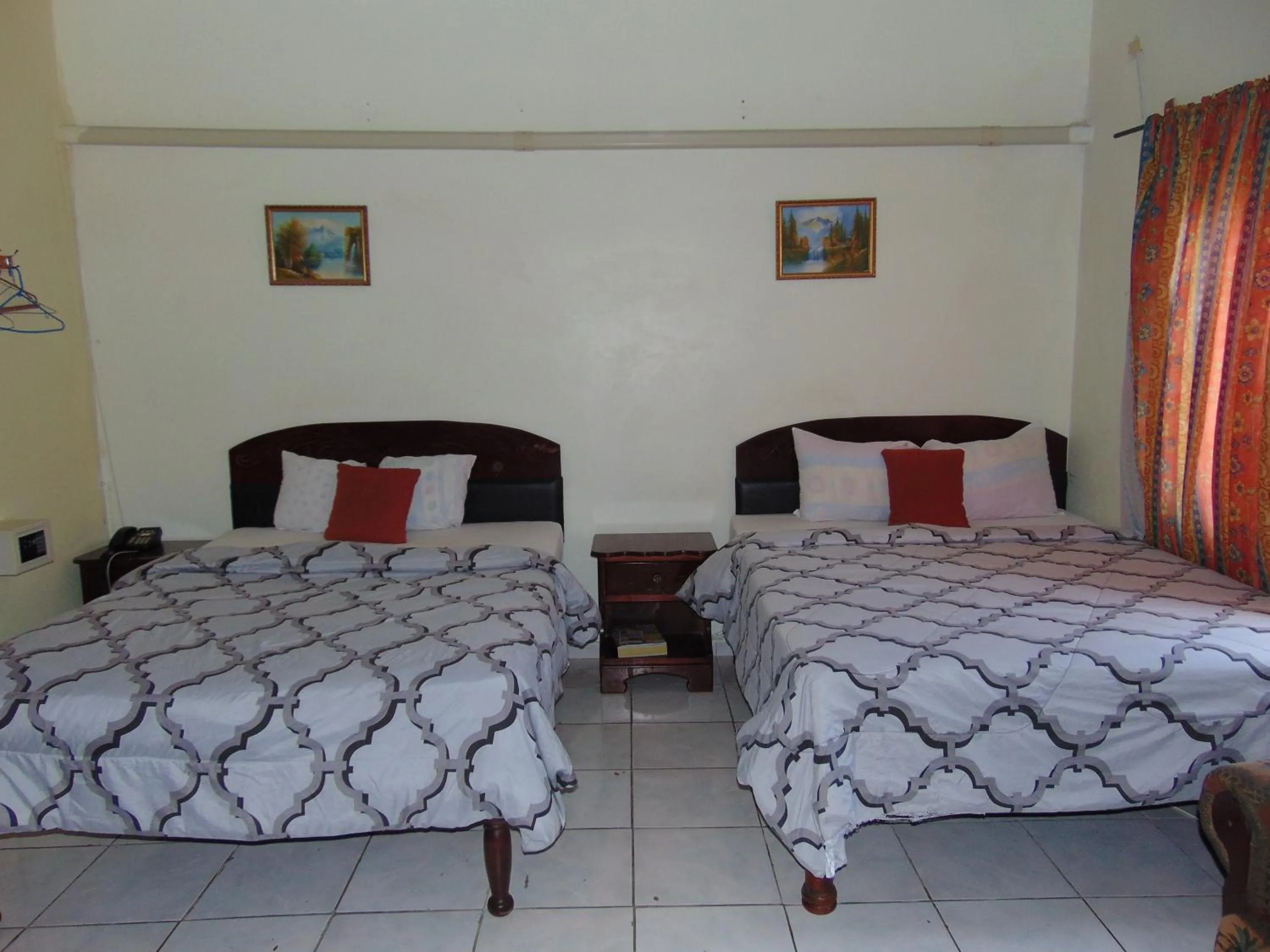 Bed in Tropical Court Hotel