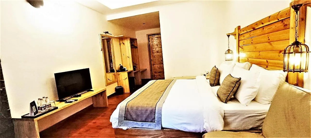 Bed in WelcomHeritage Tarangi Ramganga Resort