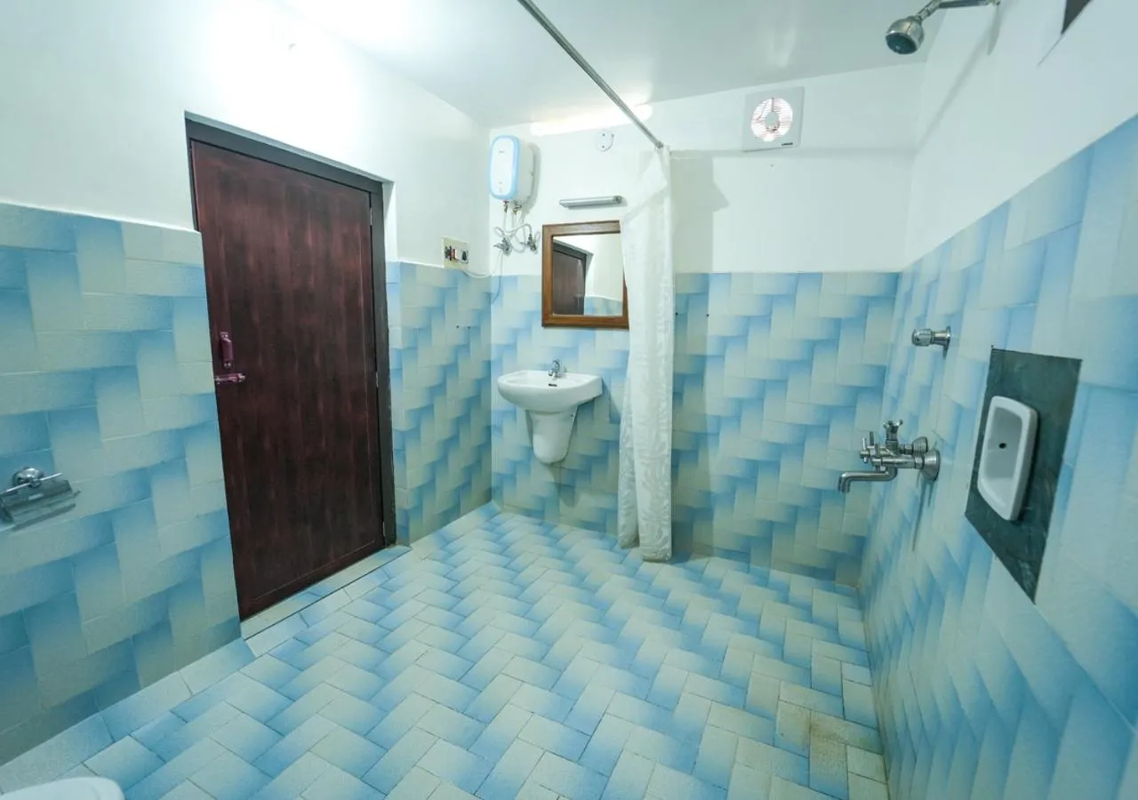 Shower in Pop Tavern Kovalam Beach Villa by VOYE HOMES