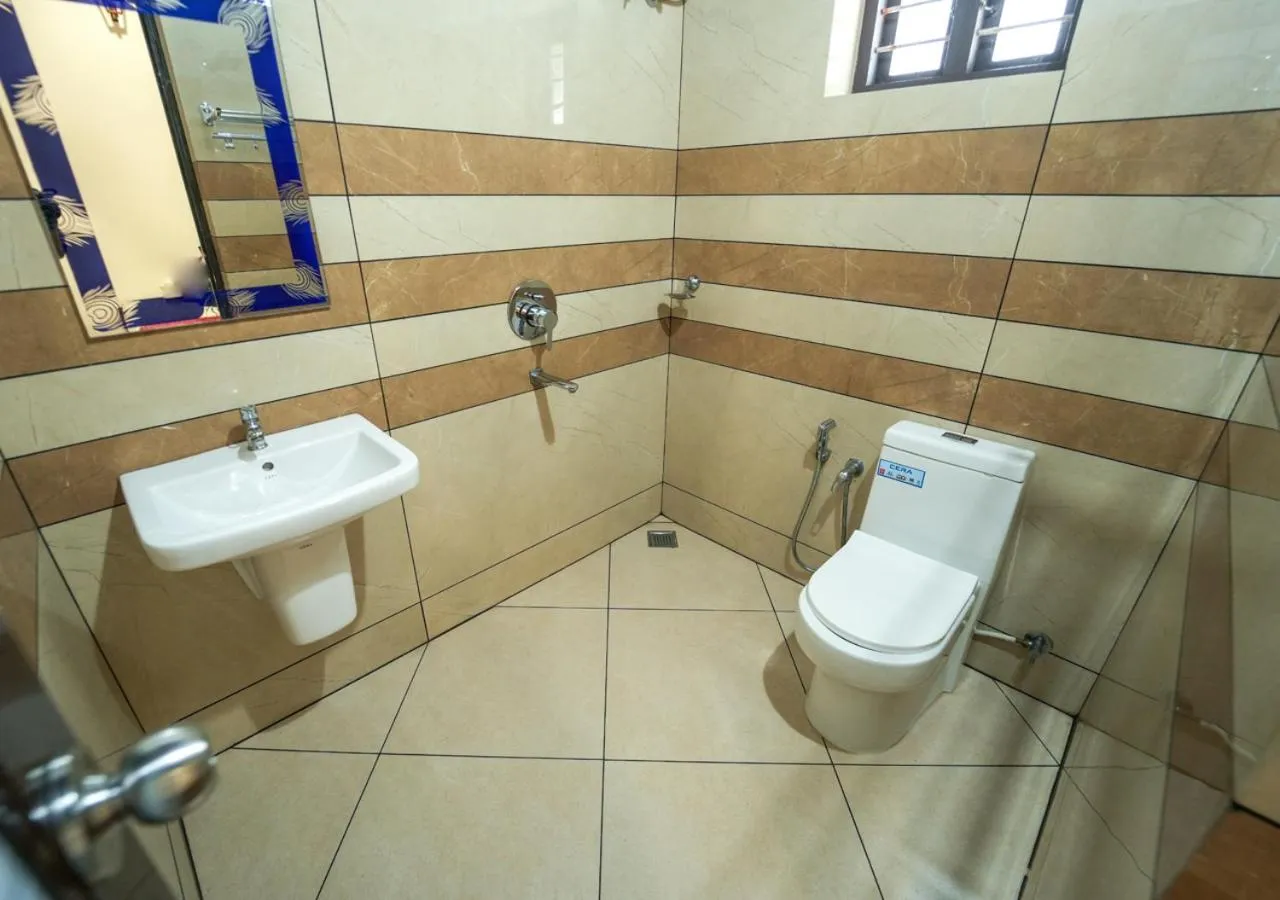 Shower in Pop Tavern Kovalam Beach Villa by VOYE HOMES