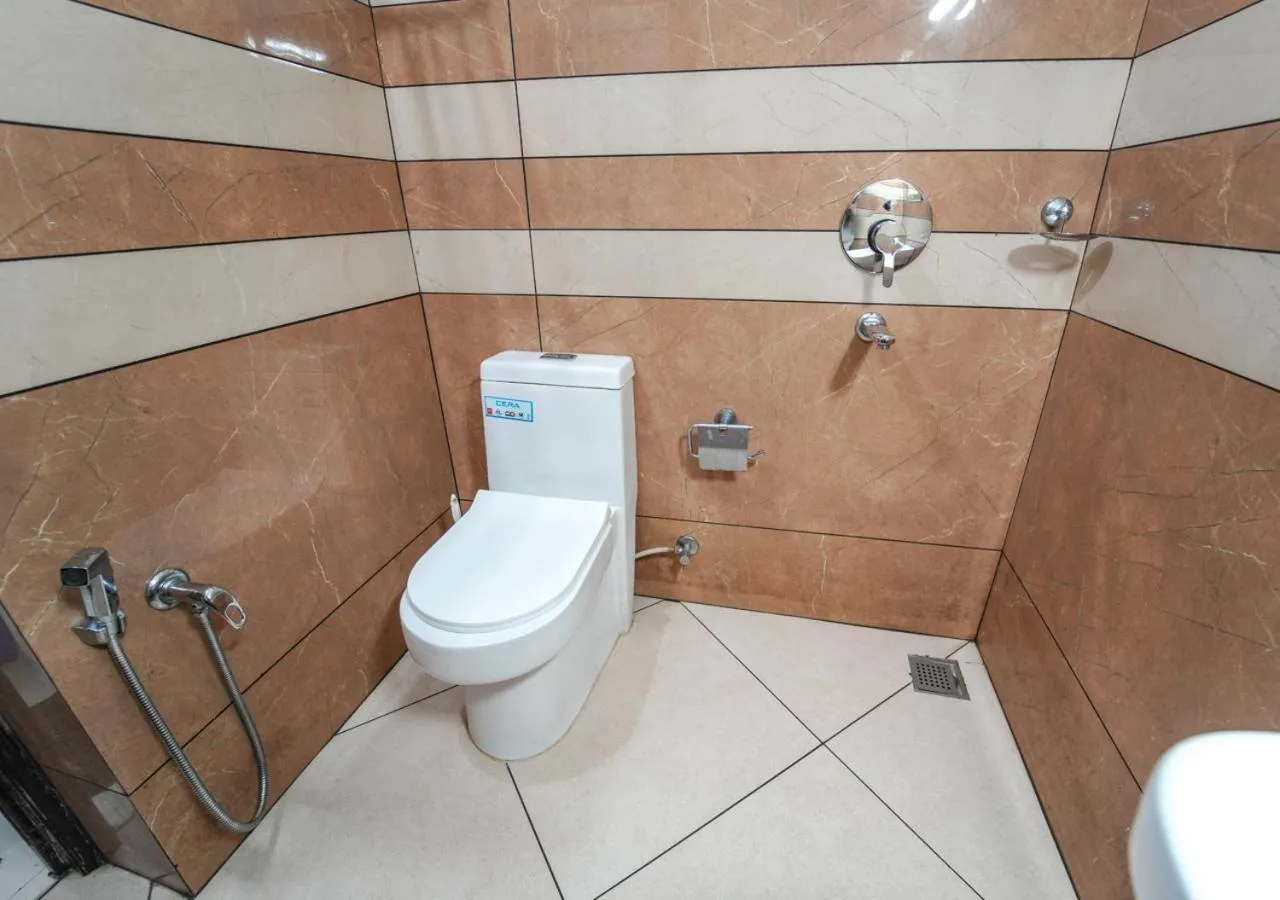 Shower in Pop Tavern Kovalam Beach Villa by VOYE HOMES