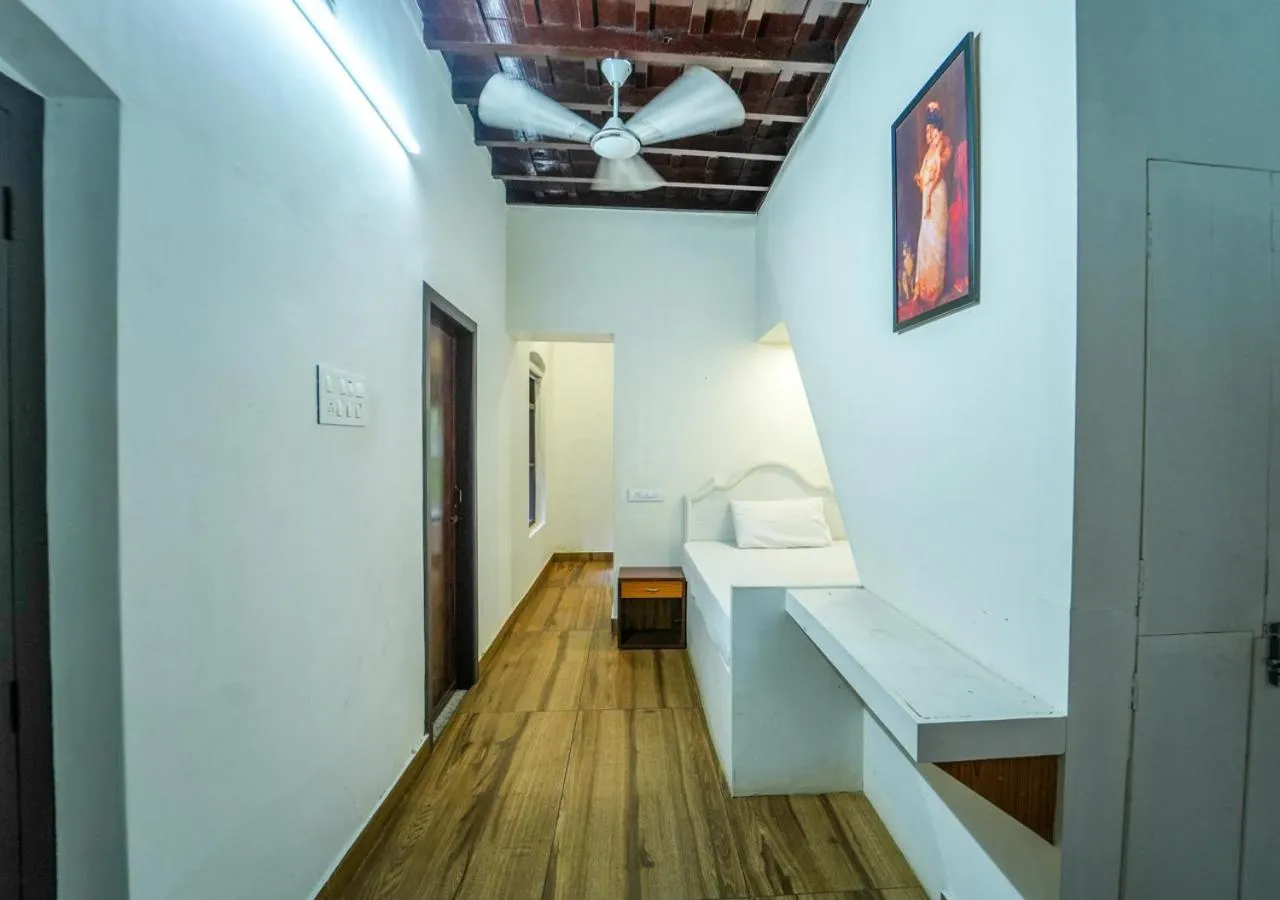 Bed in Pop Tavern Kovalam Beach Villa by VOYE HOMES