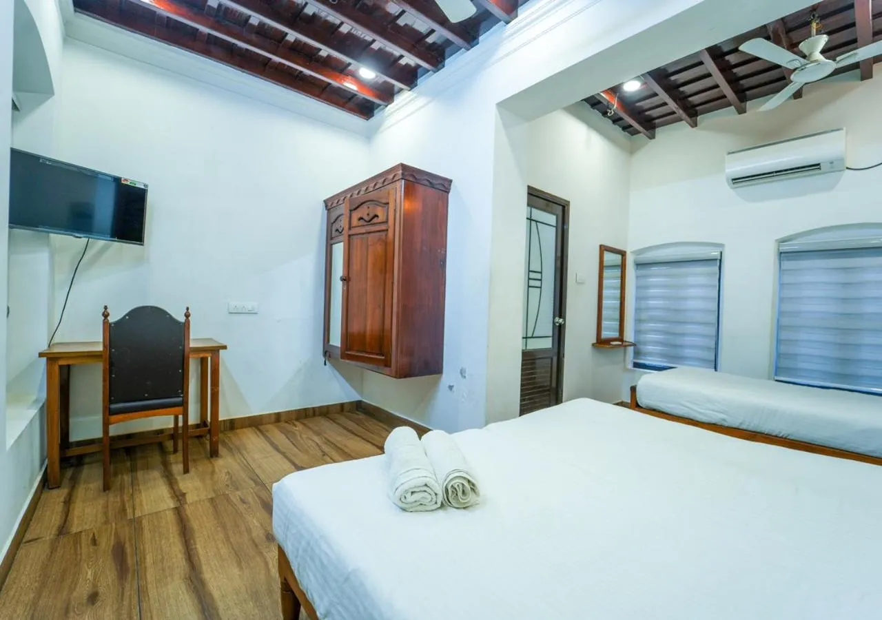 TV and multimedia, Bed in Pop Tavern Kovalam Beach Villa by VOYE HOMES