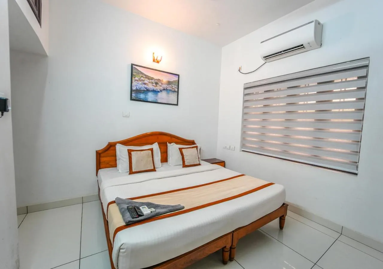 Bed in Pop Tavern Kovalam Beach Villa by VOYE HOMES