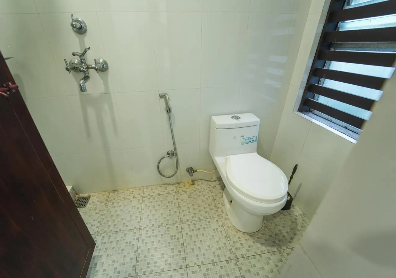 Toilet in Pop Tavern Kovalam Beach Villa by VOYE HOMES
