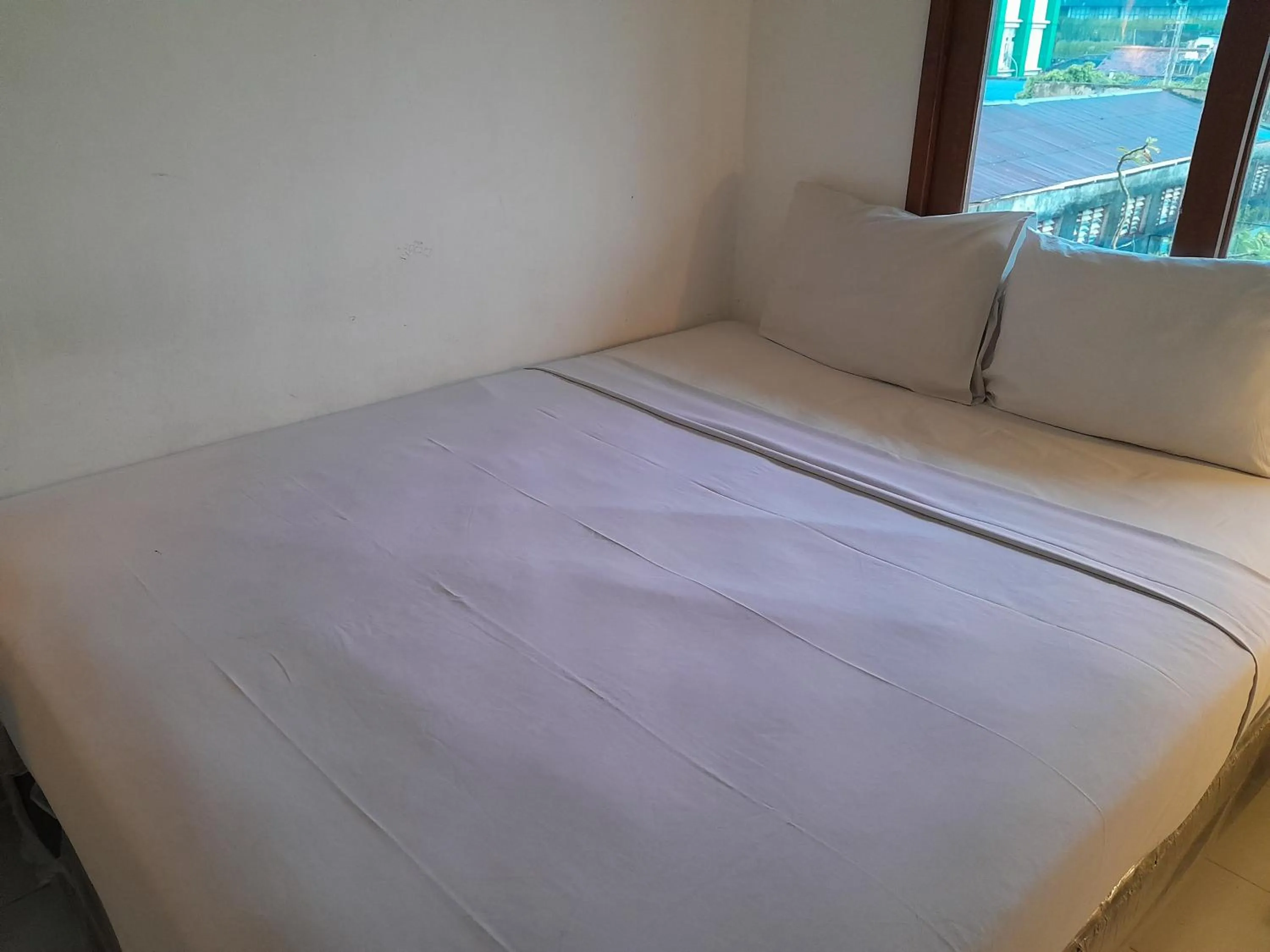 Bed in The Green Winotosastro Hotel Yogyakarta