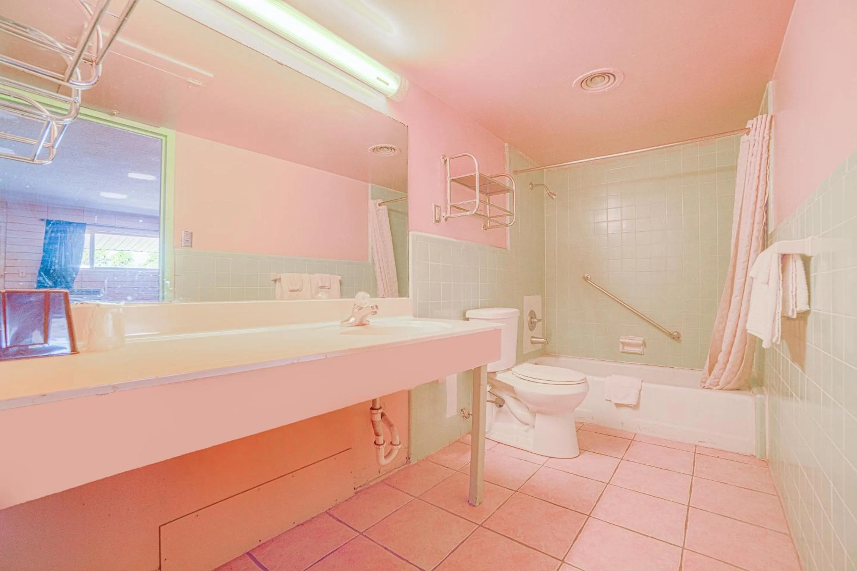 Bathroom in Town & Country Motel Bossier City by OYO