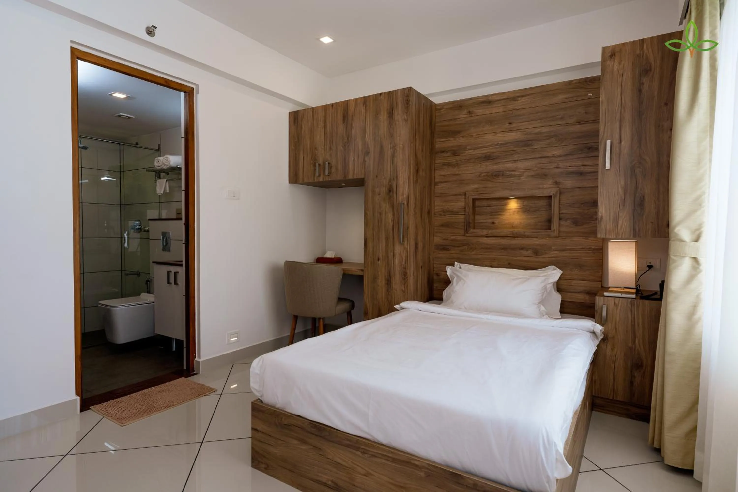 Photo of the whole room, Bed in Tea Tree Suites,Manipal