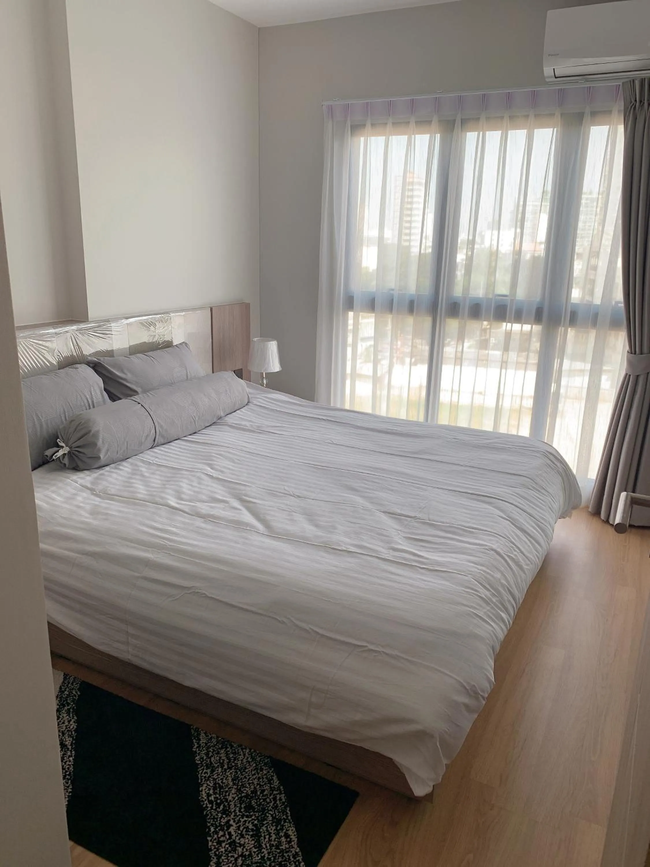 Bed in Astra Sky River Condo