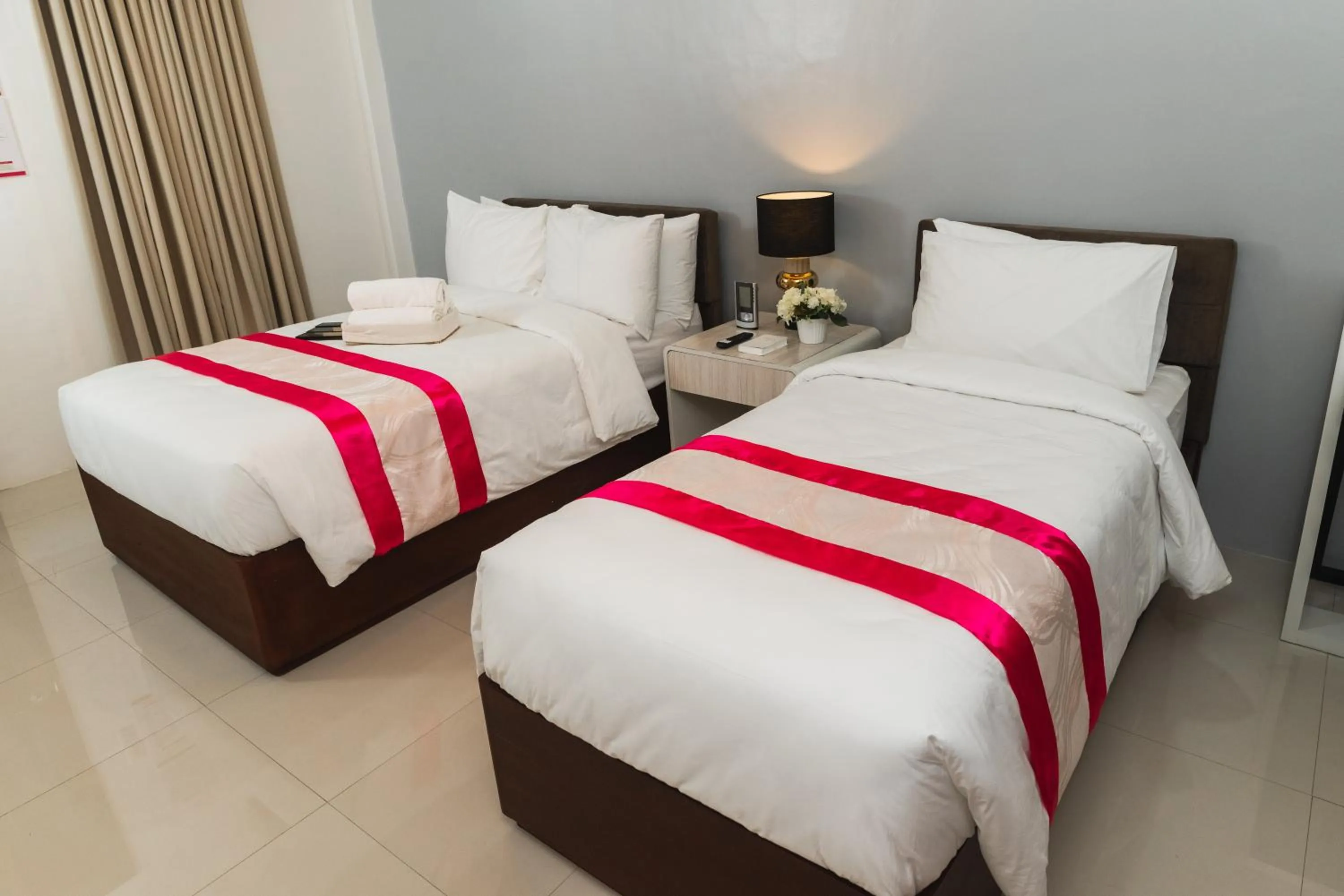 Bed in Monica Midtown Suites